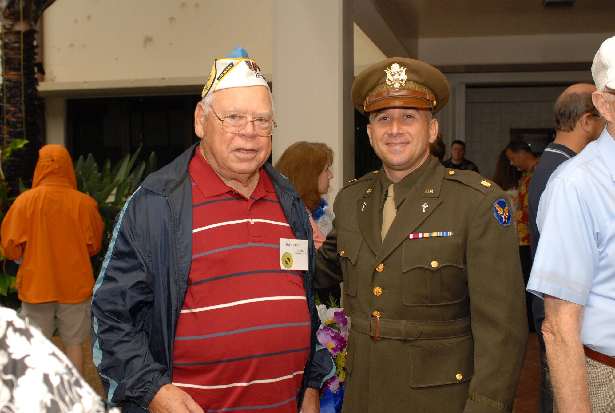 After the Dec. 7 ceremony, Chaplain Maj. Dave DePinho, 15th Airlift Wing, dressed in a throwback uniform form cira 40's era shares a moment with Doyle Ebel, a living member of the 11th Bomb Group, 26th Squadron. Photo by Oscar Hernandez.