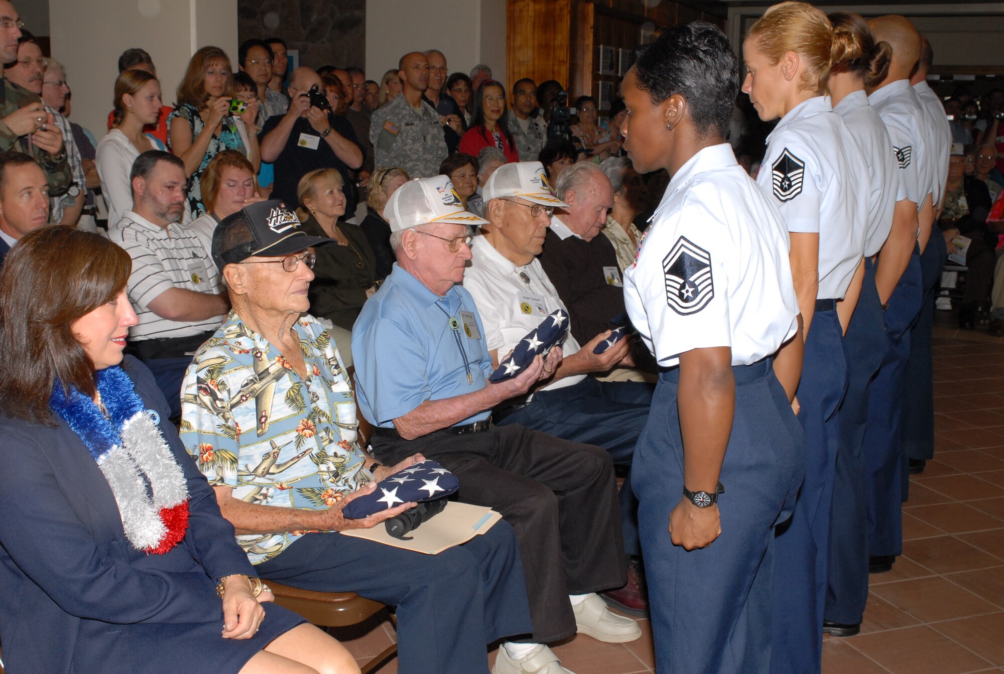 Members from the Hickam Professional Military Education Center presented a U.S. flag that was flown today over the Atterbury Memorial Park, Hickam AFB, to five survivors and one widow of a survivor of the Dec. 7, 1941 attack on Hickam Field. The ceremony was held at the Pacific Air Forces headquarters building in Courtyard of Heroes lobby, because of inclement weather.  Photo by Oscar Hernandez  

