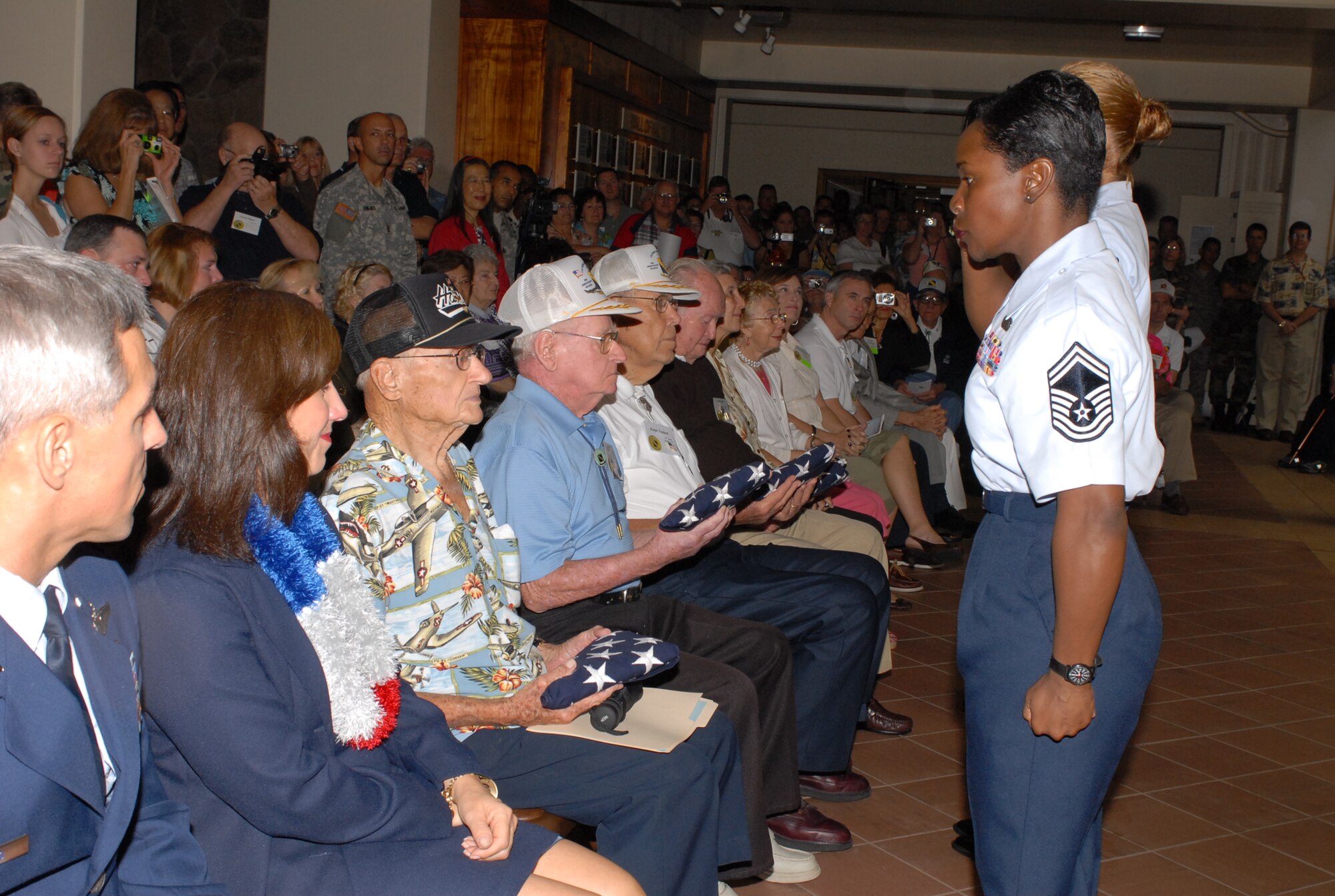 Members from the Hickam Professional Military Education Center presented a U.S. flag that was flown today over the Atterbury Memorial Park, Hickam AFB, to five survivors and one widow of a survivor of the Dec. 7, 1941 attack on Hickam Field. The ceremony was held at the Pacific Air Forces headquarters building in Courtyard of Heroes lobby, because of inclement weather.  Photo by Oscar Hernandez  

