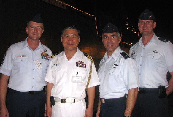 Left to Right, Chief Master Sgt. Tom Westermeyer, 15th Airlift Wing Command Chief, Republic of Korea Admiral Yim, Yim, Chul Soon, Col. JJ Torres, 15th Airlift Wing commander and Col. Jeffrey Stephenson, 15th Airlift Wing vice commander, enjoy the reception, Dec. 6. Photo by Jackie Hites 