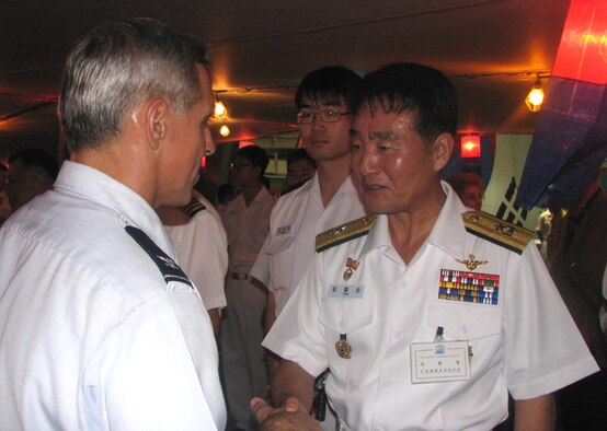 Col. JJ Torres, 15th Airlift Wing commander is greeted by Republic of Korea Admiral Yim, Chul Soon during a reception at Naval Base Pearl Harbor. The Korean Naval Academy’s Cruise Training Force docked at Pearl Harbor as part of their training prior to graduation. The training force has been sailing to different ports for about 90 days. They make their final stop in Japan before heading back to Korea. (U.S. Air Force photo/Jackie Hites) 
