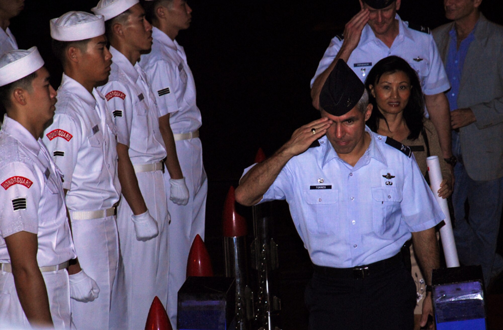 Republic of Korea Naval Honor Guard Members stand at attention as  Col. JJ Torres, 15th Airlift Wing commander, boards their ship for the Korean Naval Academy's Cruise Training Force 2007 reception at Naval Base Pearl Harbor. Photo by Staff Sgt. Erin Smith