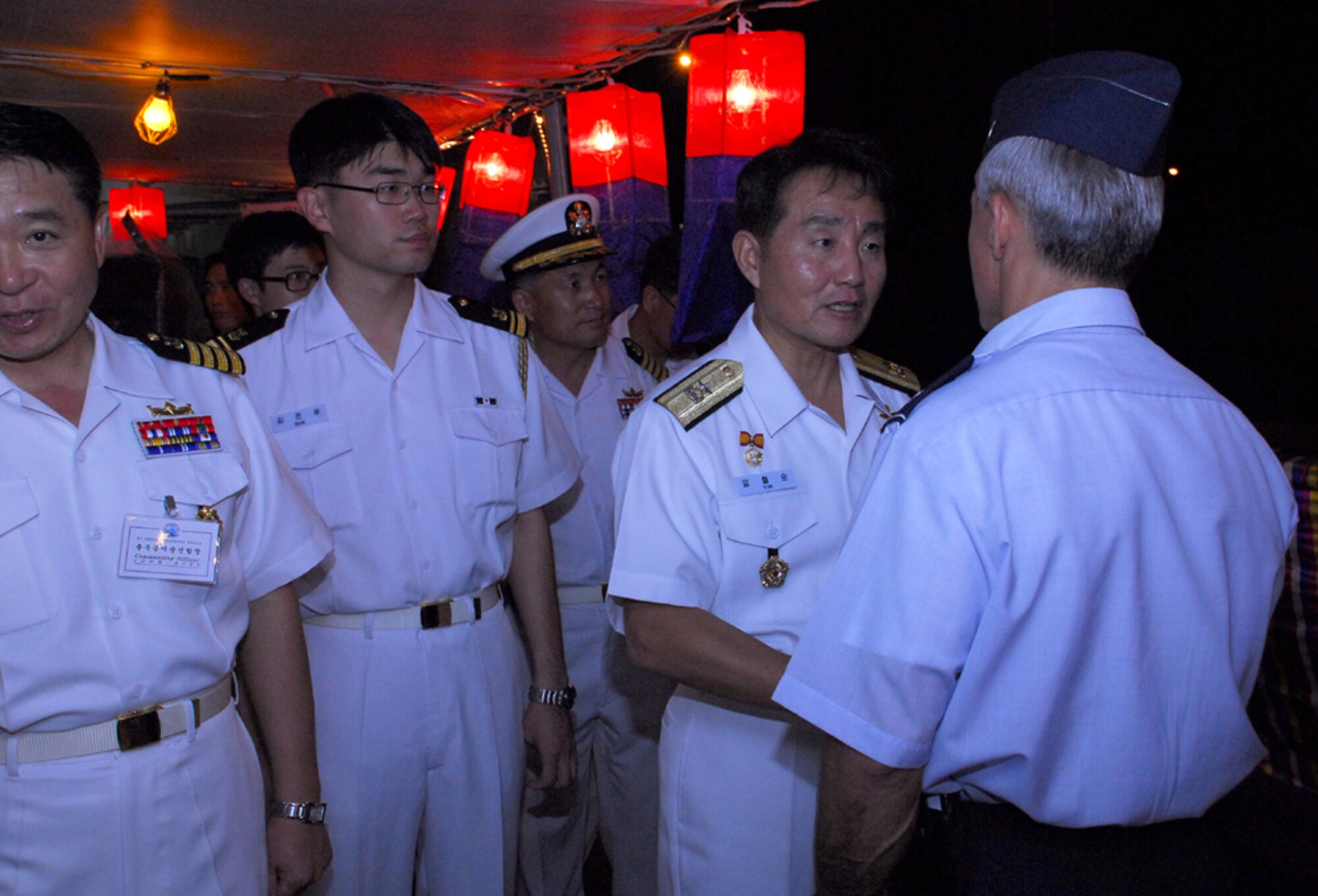 Col. JJ Torres, 15th Airlift Wing commander is greeted by Republic of Korea Admiral Yim, Chul Soon during a reception at Naval Base Pearl Harbor. The Korean Naval Academy’s cruise Training Force docked at Pearl Harbor as part of their training prior to graduation. Photo by Staff Sgt. Erin Smith