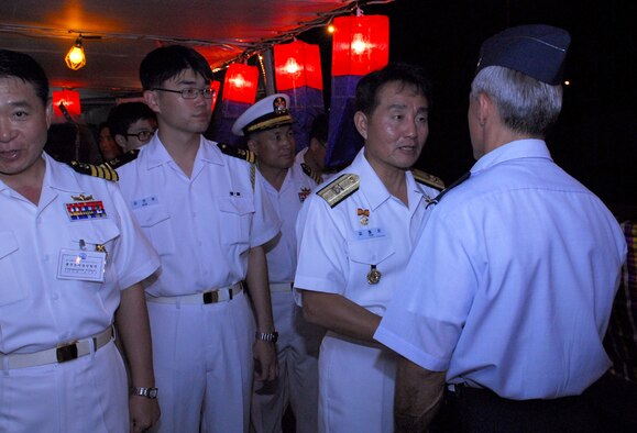 Col. JJ Torres, 15th Airlift Wing commander is greeted by Republic of Korea Admiral Yim, Chul Soon during a reception at Naval Base Pearl Harbor. The Korean Naval Academy’s cruise Training Force docked at Pearl Harbor as part of their training prior to graduation. (U.S. Air Force photo/Staff Sgt. Erin Smith)

