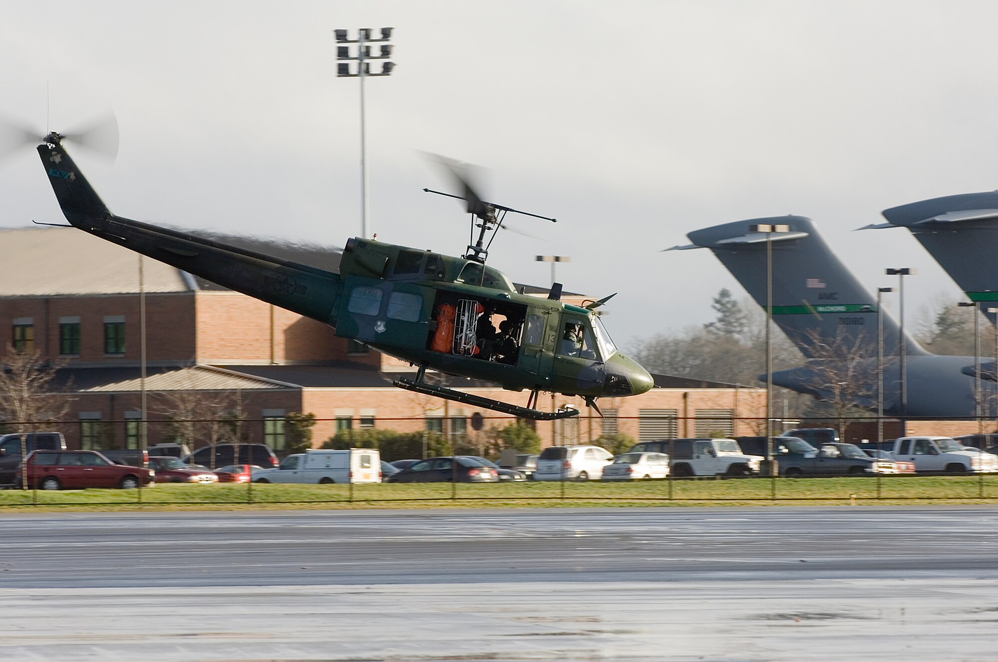 An UH-1N Huey Air Force rescue helicopter lands here Wednesday from the 36th Rescue Flight at Fairchild Air Force Base. The helicopter and crew transported a man injured during an avalanche to a hospital in northern Seattle Tuesday while supporting the state emergency response force in western Washington.Two helicopters and seven crew members from the 36th RF participated in rescue efforts in the
Bremerton area west of Seattle. They have flew numerous missions searching for distressed residents.The helicopters were temporarily based here during the rescue efforts. (Photo by Abner Guzman)