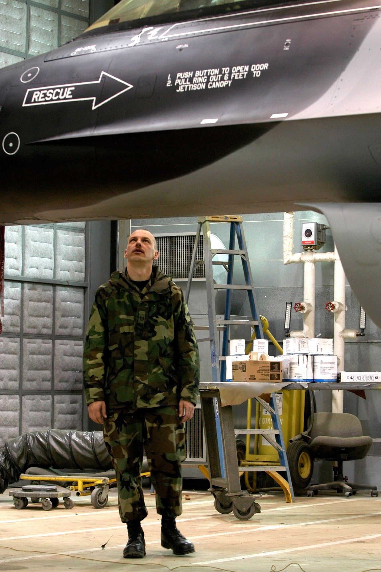 Tech. Sgt. Brian Coffel looks over a newly painted arctic scheme F-16 Fighting Falcon Nov 30 at Kunsan Air Base, South Korea. Sergeant Coffel and other members of the 8th Maintenance Squadron painted the aircraft in preparation for an upcoming Kunsan/ Eielson F-16 swap. (U.S. Air Force photo/ Tech. Sgt. Quinton T. Burris)