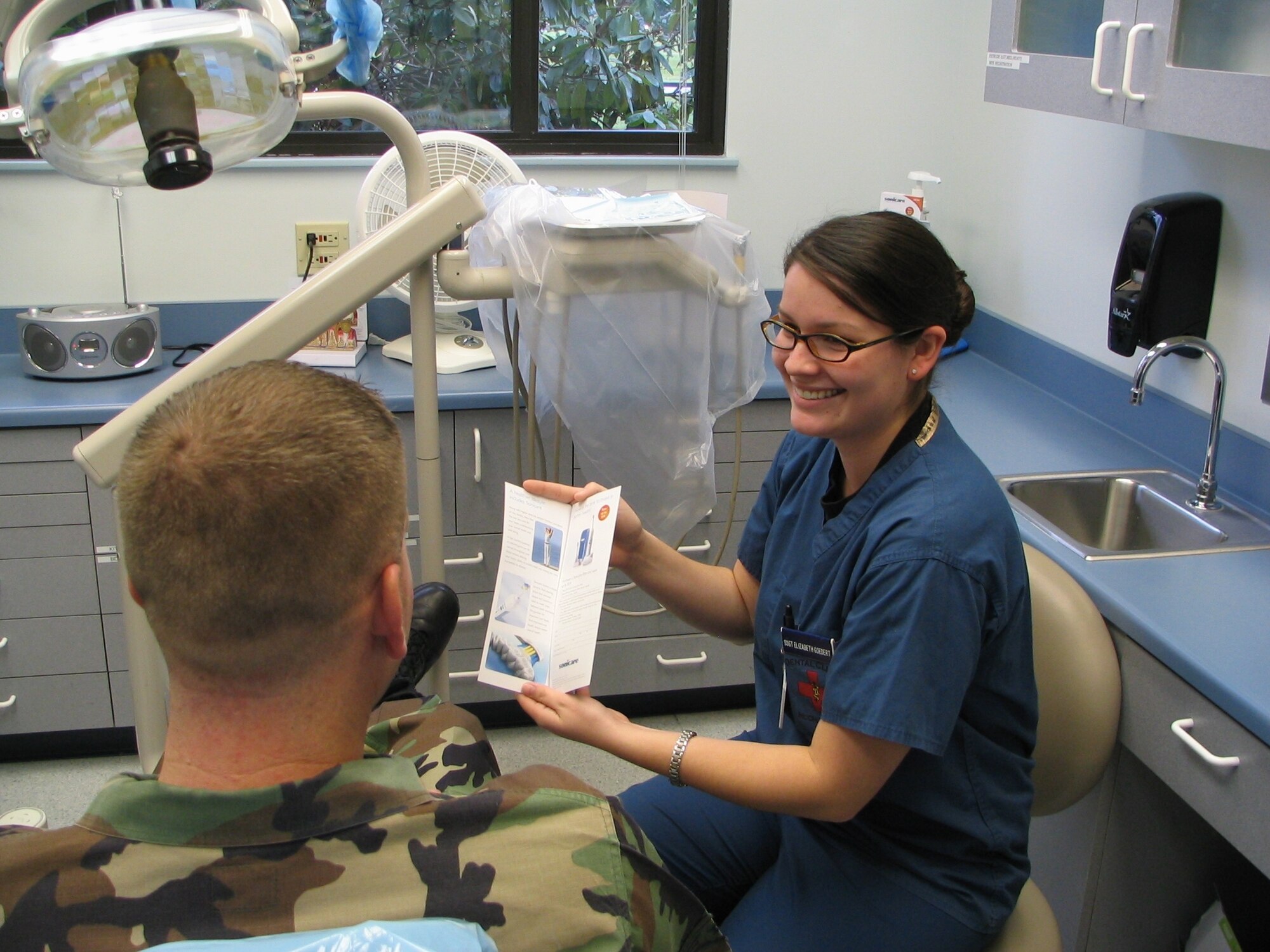 Staff Sgt. Elizabeth Goedert, 62nd Medical Operations Squadron, educates a patient
on proper oral hygiene.