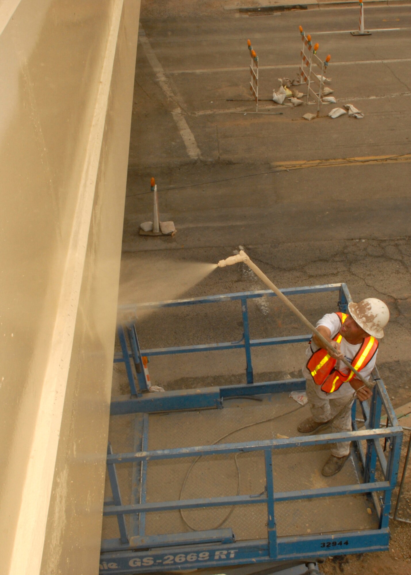 Foreman Troy Morris a painter for Dougherty Painting Company applies the last coat of paint to the Litchfield overpass structure on November 29 2007. The new bridge completion date is scheduled for January. The new bridge will connect the east and west sides of the base reducing traffic flow through the gates.  (photo by Airman 1st Class David Bulkley)