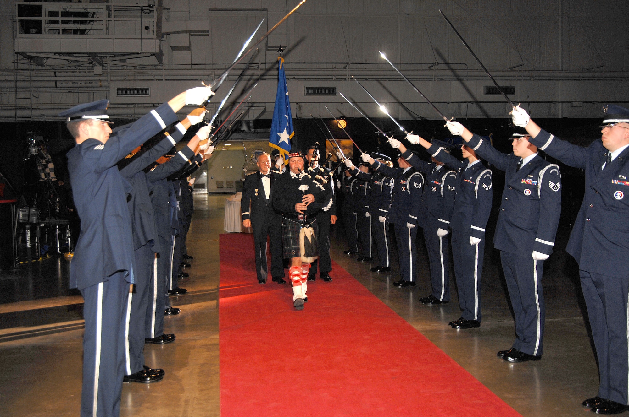 A bagpiper escorts Gen. Bruce Carlson, commander of Air Force Materiel Command, past the Honor Guard into the National Museum of the U.S. Air Force’s modern flight gallery at the beginning of the AFMC Order of the Sword ceremony Dec. 6. (Air Force photo by Ben Strasser)