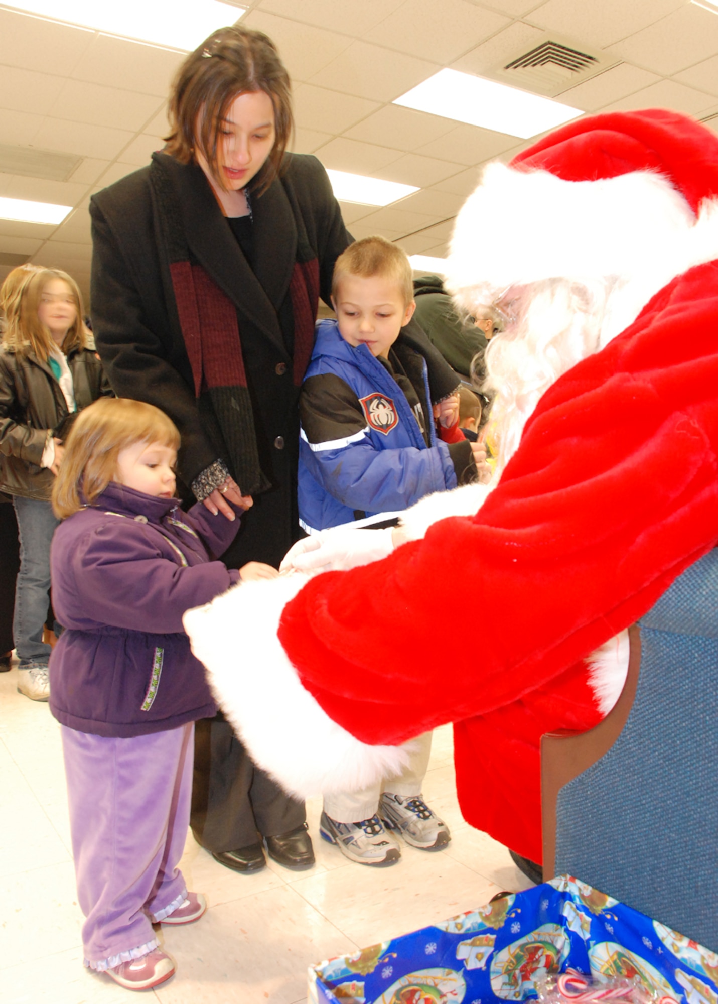McGuire children visit with Santa after the Menorah and Christmas Tree Lighting ceremony here Dec. 4. This is this first time the ceremonies were combined, signifying the unity of Team McGuire. (U.S. Air Force photo/Senior Airman Danielle Johnson)