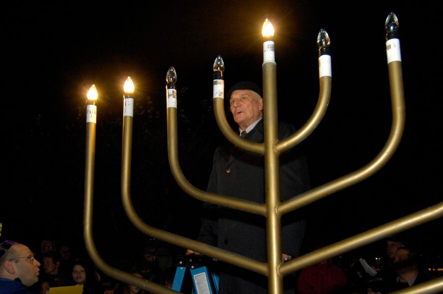 HANSCOM AFB, Mass. -- Rabbi Abraham Morhaim lights the Hanscom menorah as members of the Hanscom Jewish community gather on Dec. 5 to mark the beginning of Hanukkah. Hanukkah lasts for eight days and nights.