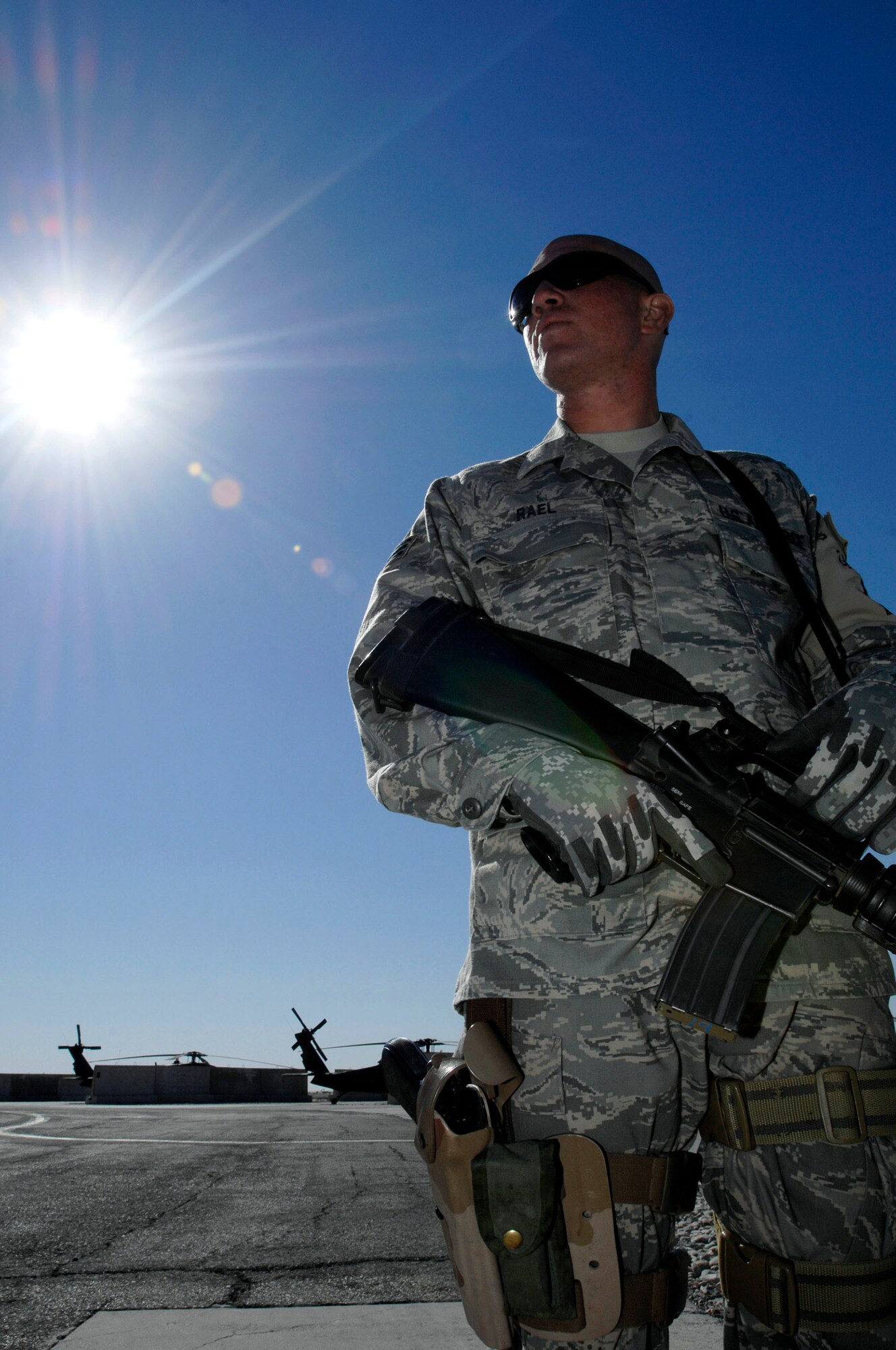 Senior Airman Paul Rael watches local Iraqi nationals working on base Nov. 27. Airman Rael is assigned to the 407th Expeditionary Security Forces Squadron force protection and is responsible for escorting and supervising the local nationals as they work. Airman Rael is an aircraft metals technology machinist from Whiteman Air Force Base, Mo. (U.S. Air Force photo/Airman 1st Class Jonathan Snyder)