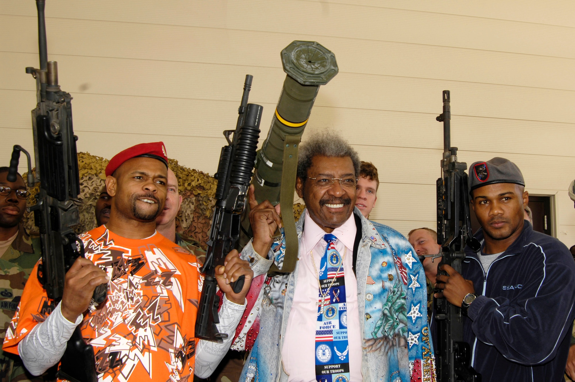 Roy Jones Jr., Don King and Felix Trinidad pose with an M-249, M-203, AT-4 rocket launcher and an M-240 during their visit to the 720th Advanced Skills Training flight Dec. 5 at Hurlburt Field, Fla. The boxers and their promoter visited Hurlburt Field as part of their tour of military installation to show support for military members. (U.S. Air Force photo/Airman 1st Class Sheila deVera) 
