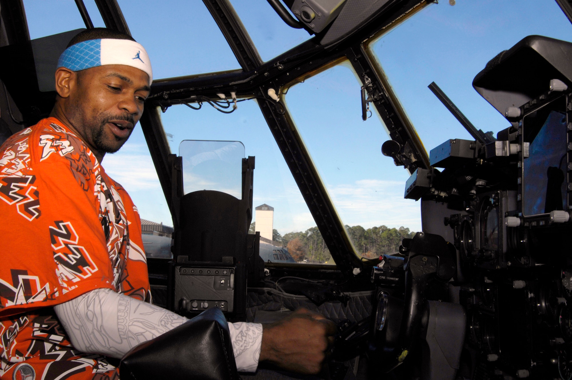 Professional boxer Roy Jones Jr. sits in the cockpit of an AC-130U Spooky Gunship Dec. 5 at Hurlburt Field, Fla. Mr. Jones, boxer Felix Trinidad and promoter Don King visited Hurlburt Field as part of their tour of military installation to show support for military members. (U.S. Air Force photo/Airman 1st Class Sheila deVera)
