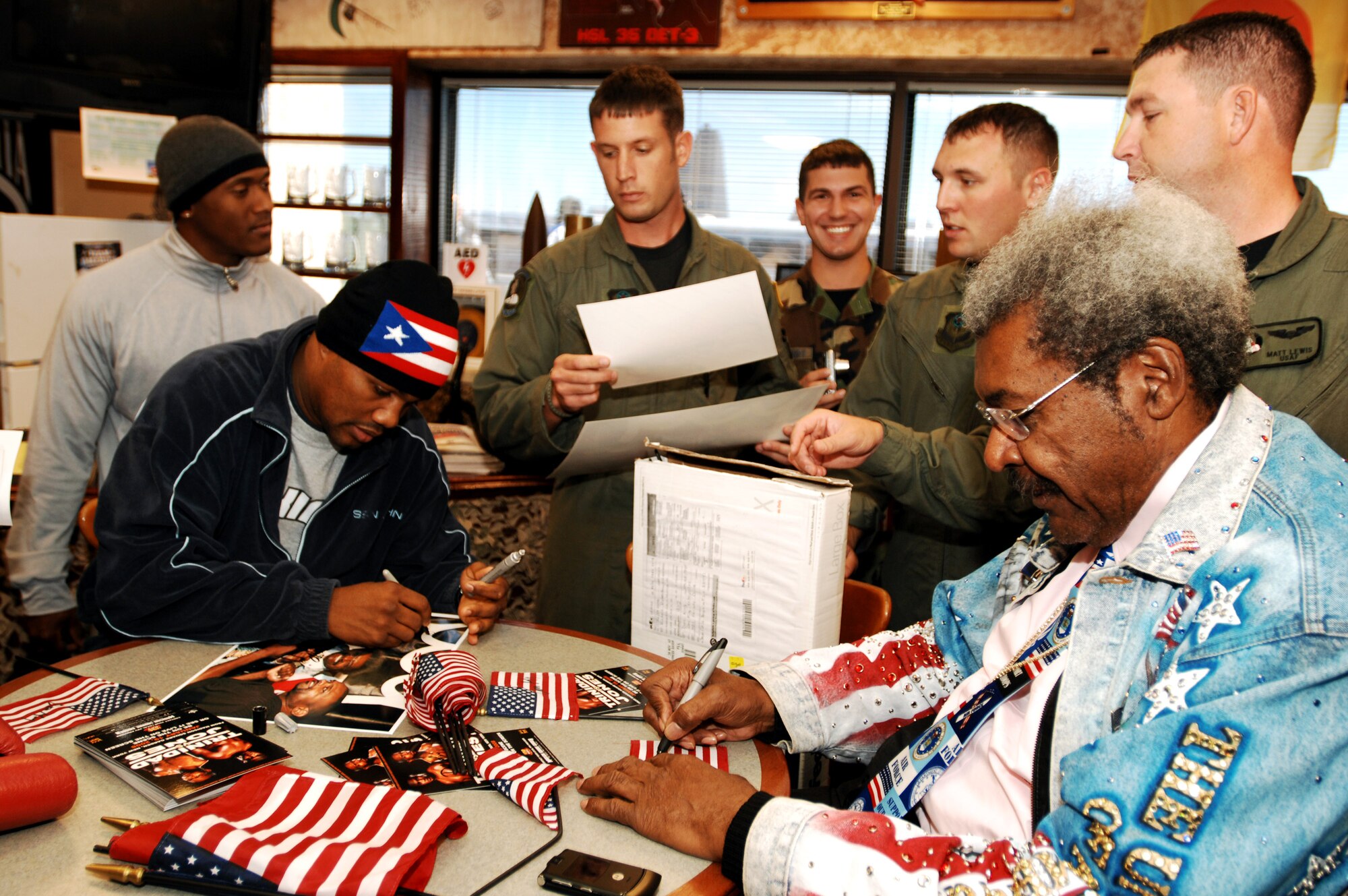 Professional boxer Felix Trinidad (left) and promoter Don King (right) sign autographs and take pictures with Airmen from the 4th Special Operations Squadron Dec. 5 at Hurlburt Field, Fla. Mr. Trinidad, Mr. King and boxer Roy Jones Jr., visited Hurlburt Field as part of their tour of military installations to show support for military members. (U.S. Air Force photo/Airman 1st Class Jason Epley)
