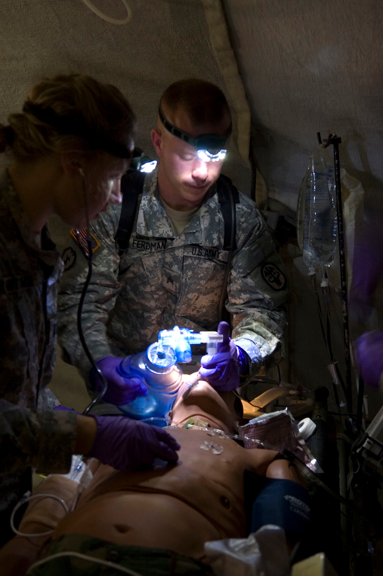 Sergeant Ryan Ferdman (U.S. Army) a respiratory therapist with the Pacific Air Forces Critical Care Air Transport Team, Tripler Army Medical Center, Honolulu, Hawaii helps a simulated patient breathe during Critical Care Air Transport Team training conducted by the United States Air Force School of Aerospace Medicine at Brooks City-Base, Texas. The week-long course prepares CCATT members for medical evacuation operations and duties. (U.S. Air Force photo/Steve Thurow) 