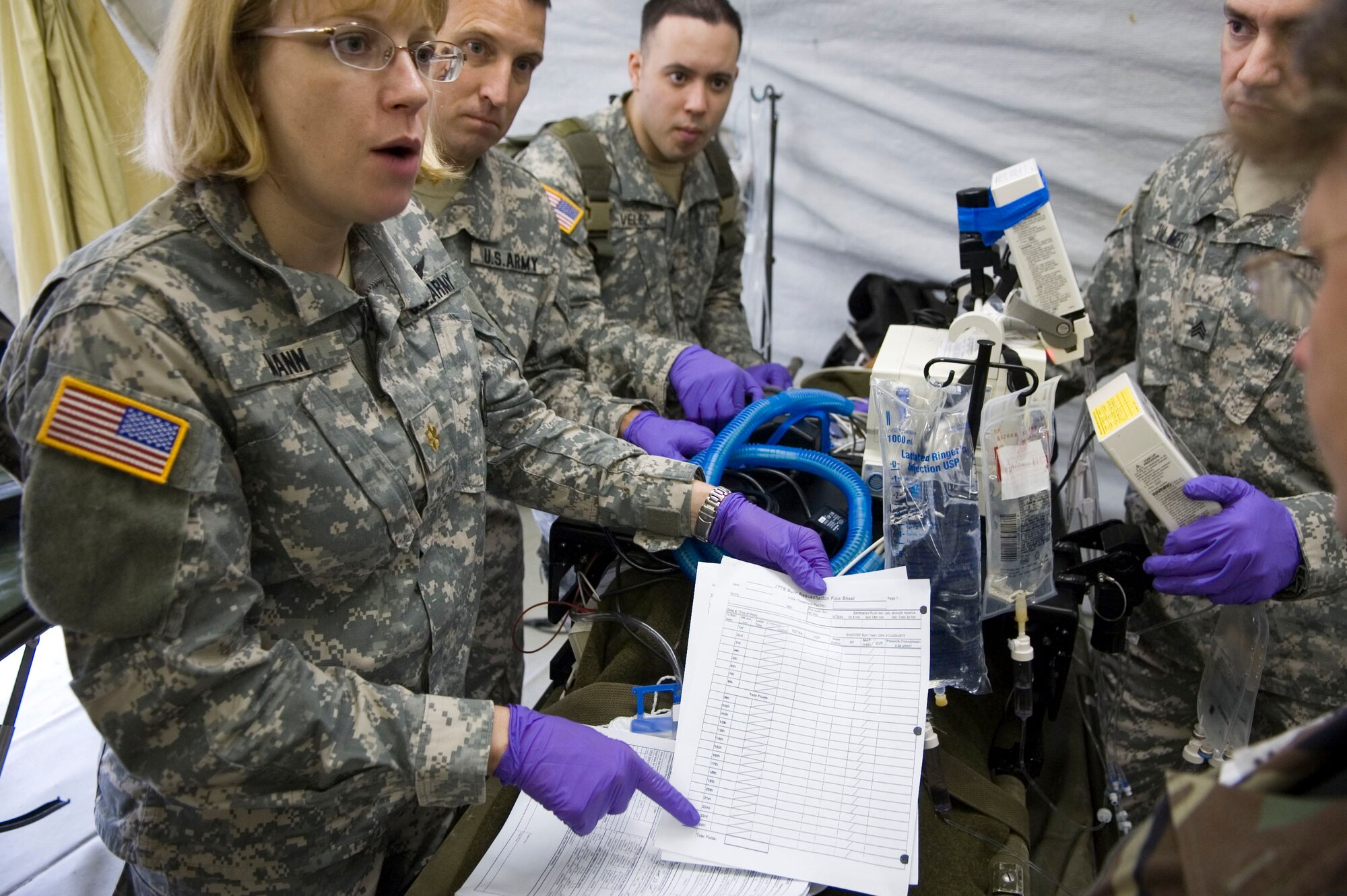 Major Elizabeth Mann (U.S. Army), a registered nurse with the  Special Medical Augmentation Response Team based at Brooke Army Medical Center, San Amntonio, Texas goes over a simulated burn victims' respiratory log sheet during Critical Care Air Transport Team training at the United States Air Force School of Aerospace Medicine, Brooks City-Base, Texas. The week-long course prepares CCATT members for medical evacuation operations and duties.  (U.S. Air Force photo/Steve Thurow) 