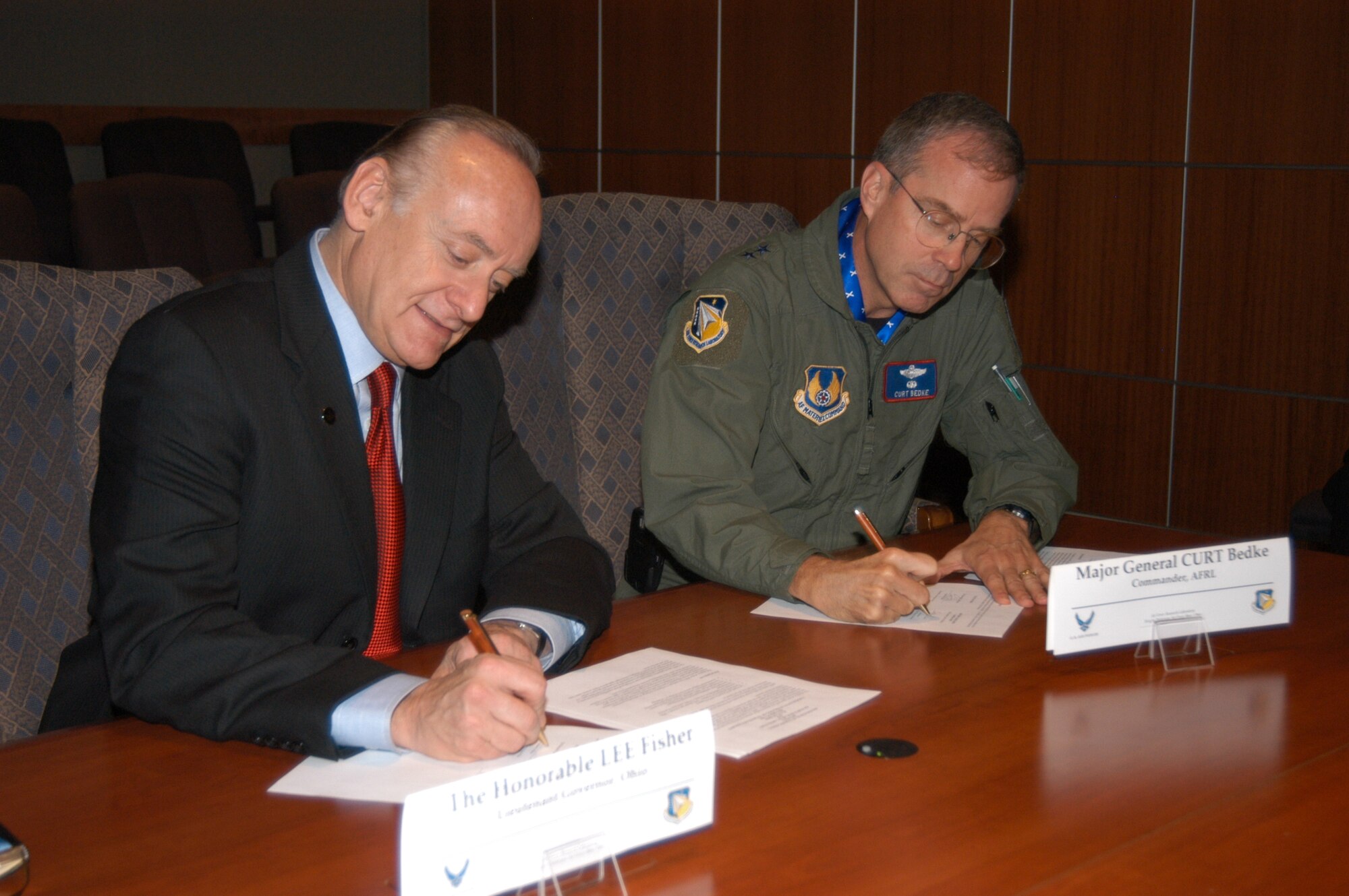 Lt. Governor Lee Fisher and Air Force Research Laboratory commander Maj. Gen. Curtis Bedke, sign the Memorandum of Understanding which will encourage collaboration for Air Force research and economic growth. (Air Force photo by Jeremy Patton) 