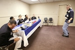 Airman 1st Class Brian Carmack solicits a laugh from a panel of judges during a comedy routine in the "specialty" audition during the Air Force World Wide Talent Contest held at Lackland Air Force Base, Texas, from December 2-10. The five-person panel of current and former Tops in Blue judges are (from left) Staff Sgt. Daniel Rutherford, Fort Meade, Maryland; Staff Sgt. LaTanza Meabon-Whiteside, Little Rock AFB, Ark.; Staff Sgt. Amber Young, Offutt AFB, Neb.; Staff Sgt. Tatenisia Stirrup, Tinker AFB, Okla.; and Senior Airman Bryce Zabric, Dyess AFB, Texas. World Wide is the first step to Tops in Blue.  Airman Carmack, a dental assistant at Lackland AFB, is competing for male vocalist for the 2008 Tops in Blue show.  (U.S. Air Force photo/Robbin Cresswell)