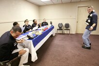 Airman 1st Class Brian Carmack solicits a laugh from a panel of judges during a comedy routine in the "specialty" audition during the Air Force World Wide Talent Contest held at Lackland Air Force Base, Texas, from December 2-10. The five-person panel of current and former Tops in Blue judges are (from left) Staff Sgt. Daniel Rutherford, Fort Meade, Maryland; Staff Sgt. LaTanza Meabon-Whiteside, Little Rock AFB, Ark.; Staff Sgt. Amber Young, Offutt AFB, Neb.; Staff Sgt. Tatenisia Stirrup, Tinker AFB, Okla.; and Senior Airman Bryce Zabric, Dyess AFB, Texas. World Wide is the first step to Tops in Blue.  Airman Carmack, a dental assistant at Lackland AFB, is competing for male vocalist for the 2008 Tops in Blue show.  (U.S. Air Force photo/Robbin Cresswell)
