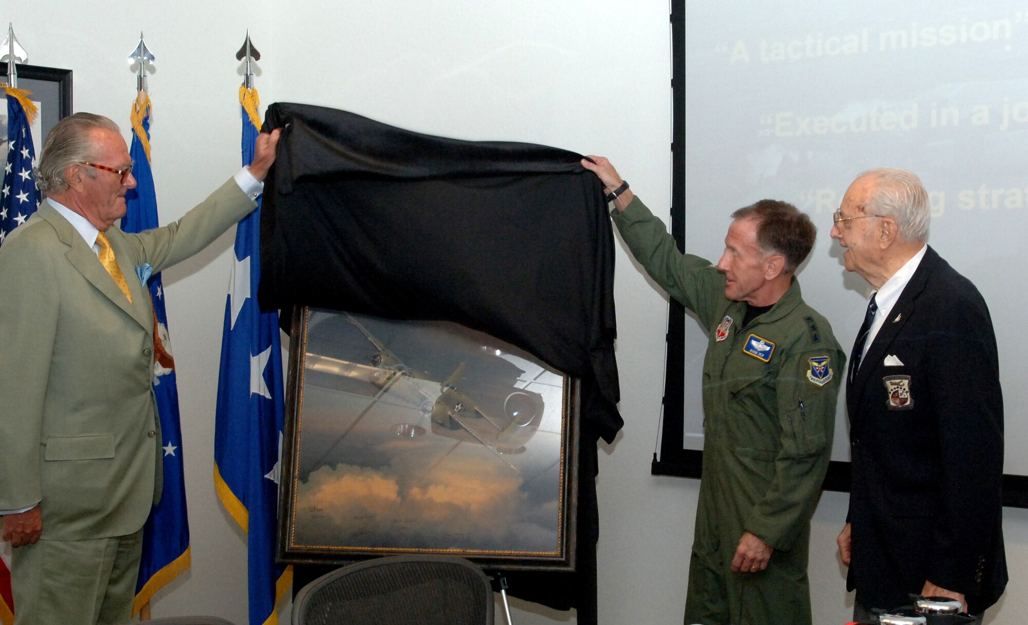Count Ferdinand von Galen presents a limited edition painting, West Bound: A Date with the General, to Lt. Gen. Norman Seip, commander 12th Air Force and Air Forces Southern, and to Maj. Gen. (retired) David Jones, one of the original Doolittle Raiders. The painting, created by world-renowned aviation artist William S. Phillips, captures the courageous actions of the famed “Doolittle Raiders” during the 1942 raid of Japan. The painting, according to Count von Galen, was donated to the James H. Doolittle Combined Air and Space Operations Center because the command embodies the character of the original Raiders in their work around the world.   (U.S. Air Force photo by TSgt Kerry Jackson)