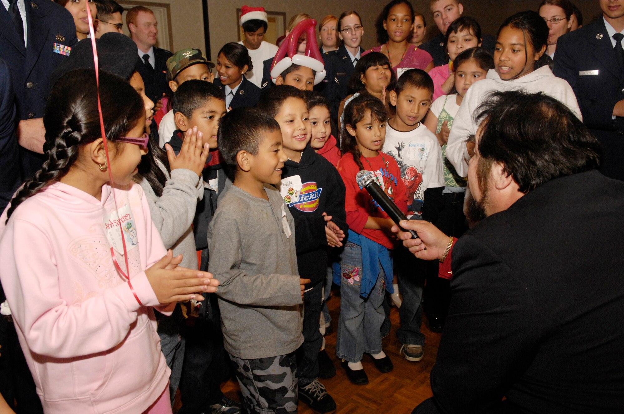 VANDENBERG AIR FORCE BASE, Calif. -- Opera Singer Samuel Delpalma sings "Santa Clause Is Coming to Town", with the children during Operation Kids Christmas on Dec. 1 in the Pacific Cost Club. Operation Kids Christmas 2007 provided over two-hundred underprivileged children with presents and a holiday dinner. The event was made possible through multiple fund raising events and corporate sponsors. This was the 48th OKC held at Vandenberg.  (U.S. Air Force photo/Airman 1st Class Nichelle Griffiths)