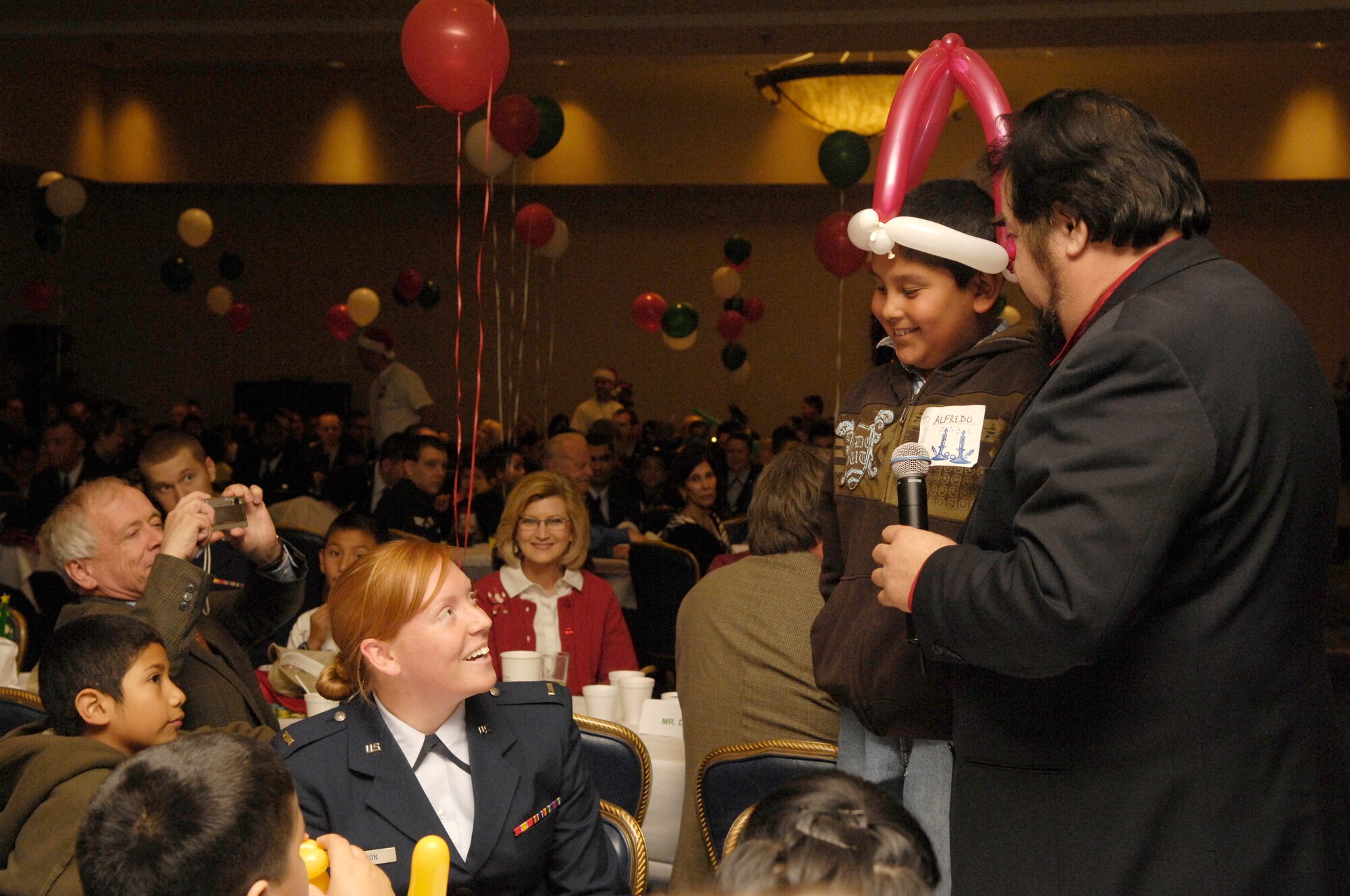 VANDENBERG AIR FORCE BASE, Calif. -- Opera singer Samuel Delpalama sings with Alferdo Macedo during Operation Kids Christmas on Dec. 1 in the Pacific Cost Club. Operation Kids Christmas 2007 provided over two-hundred underprivileged children with presents and a holiday dinner. The event was made possible through multiple fund raising events and corporate sponsors. This was the 48th OKC held at Vandenberg.  (U.S. Air Force photo/Airman 1st Class Nichelle Griffiths)