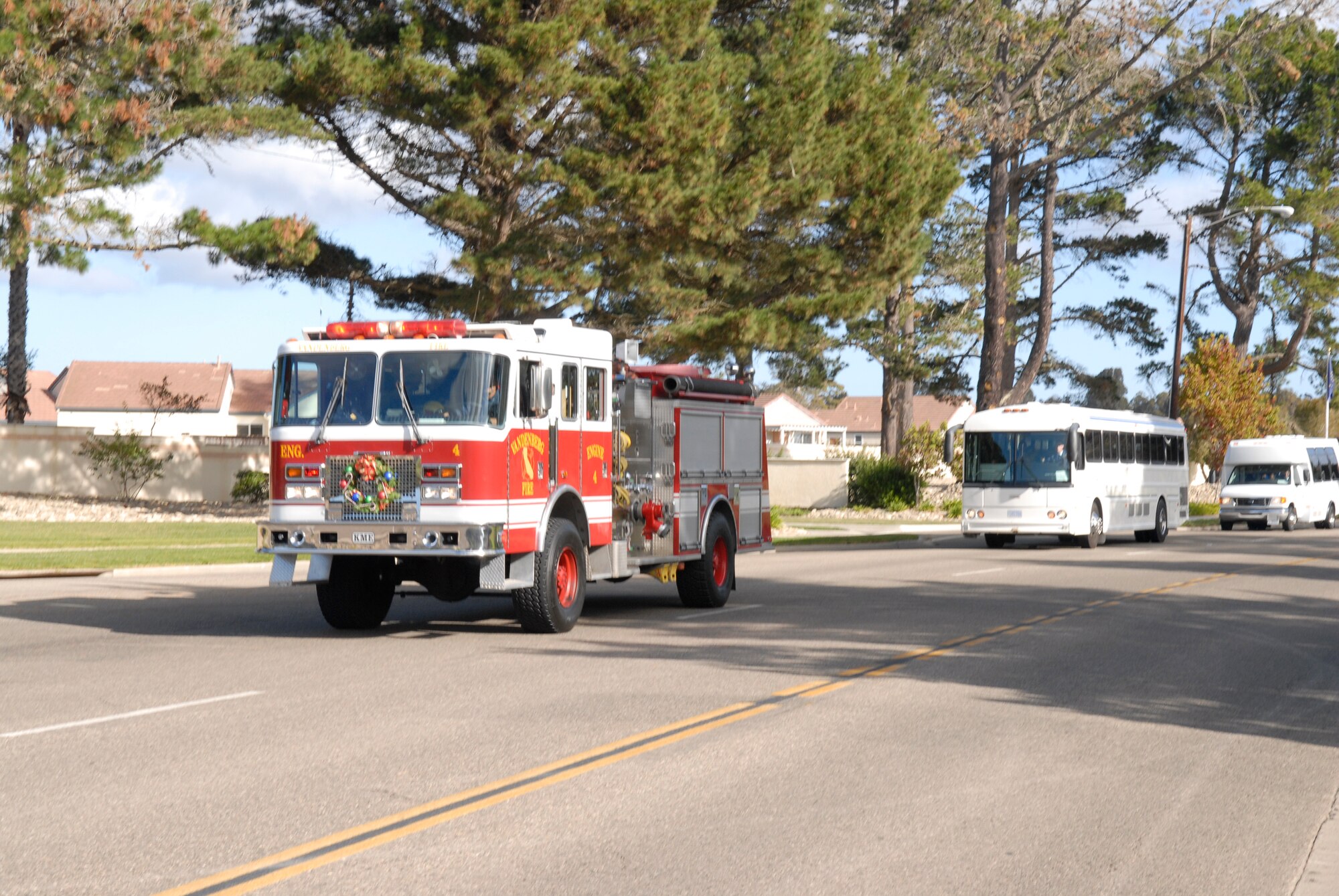VANDENBERG AIR FORCE BASE, Calif. -- A Vandenberg Fire Engine leads shuttle buses full of children to the Pacific Coast club to kick off Operation Kids Christmas on Dec. 1.  Operation Kids Christmas is an annual event which involves about 200 children. Each child is assigned to an Airman and spends the day watching a magic show, making crafts, hearing an opera singer, and of course meeting Santa. (U.S. Air Force photo\Airman 1st Class Adam Guy)   