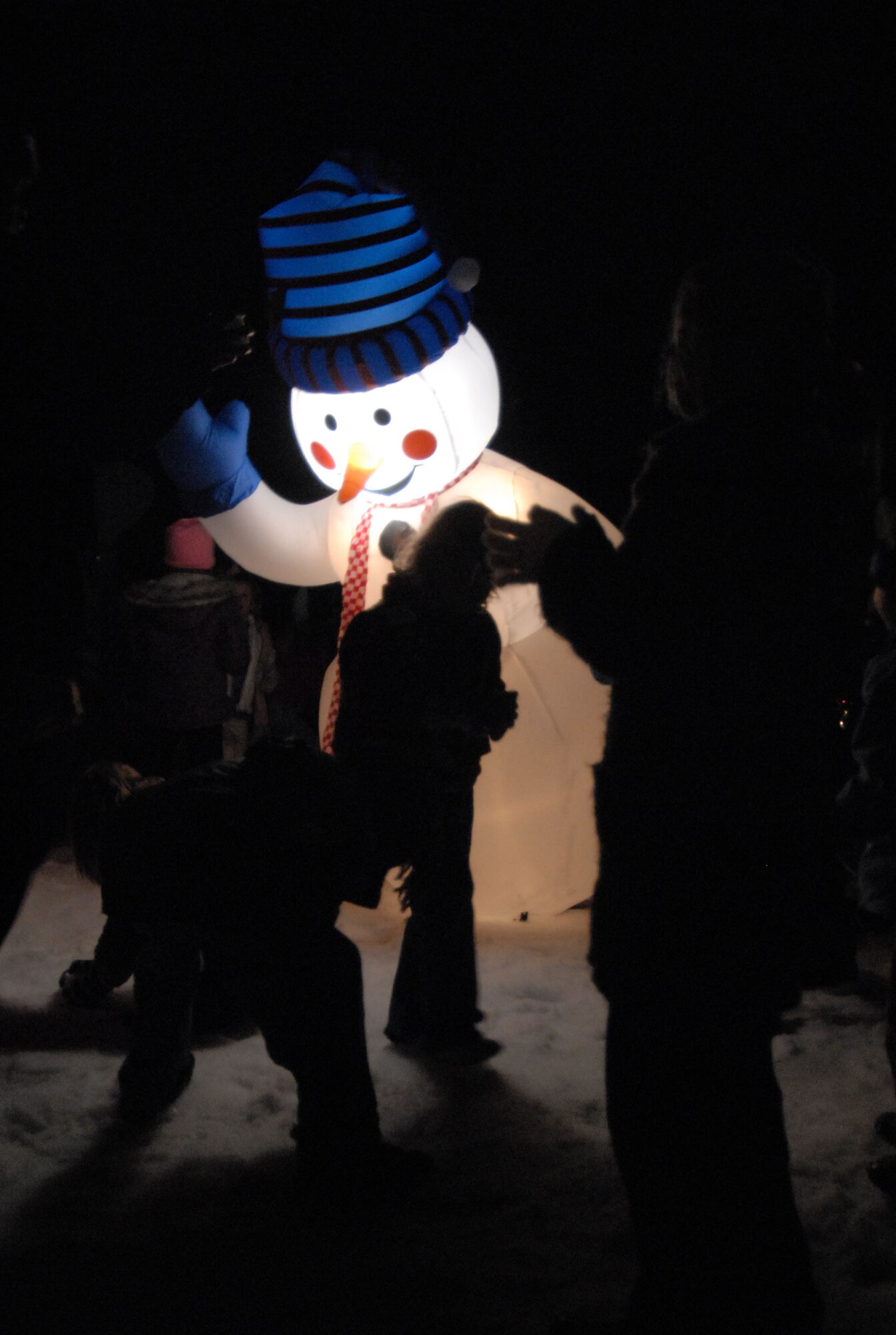 Team Edwards children play with the inflatable "Mr. Snowman" during the Christmas tree lighting ceremony at the Base Exchange parking lot here Dec. 5. (Photo by Senior Airman Julius Delos Reyes)