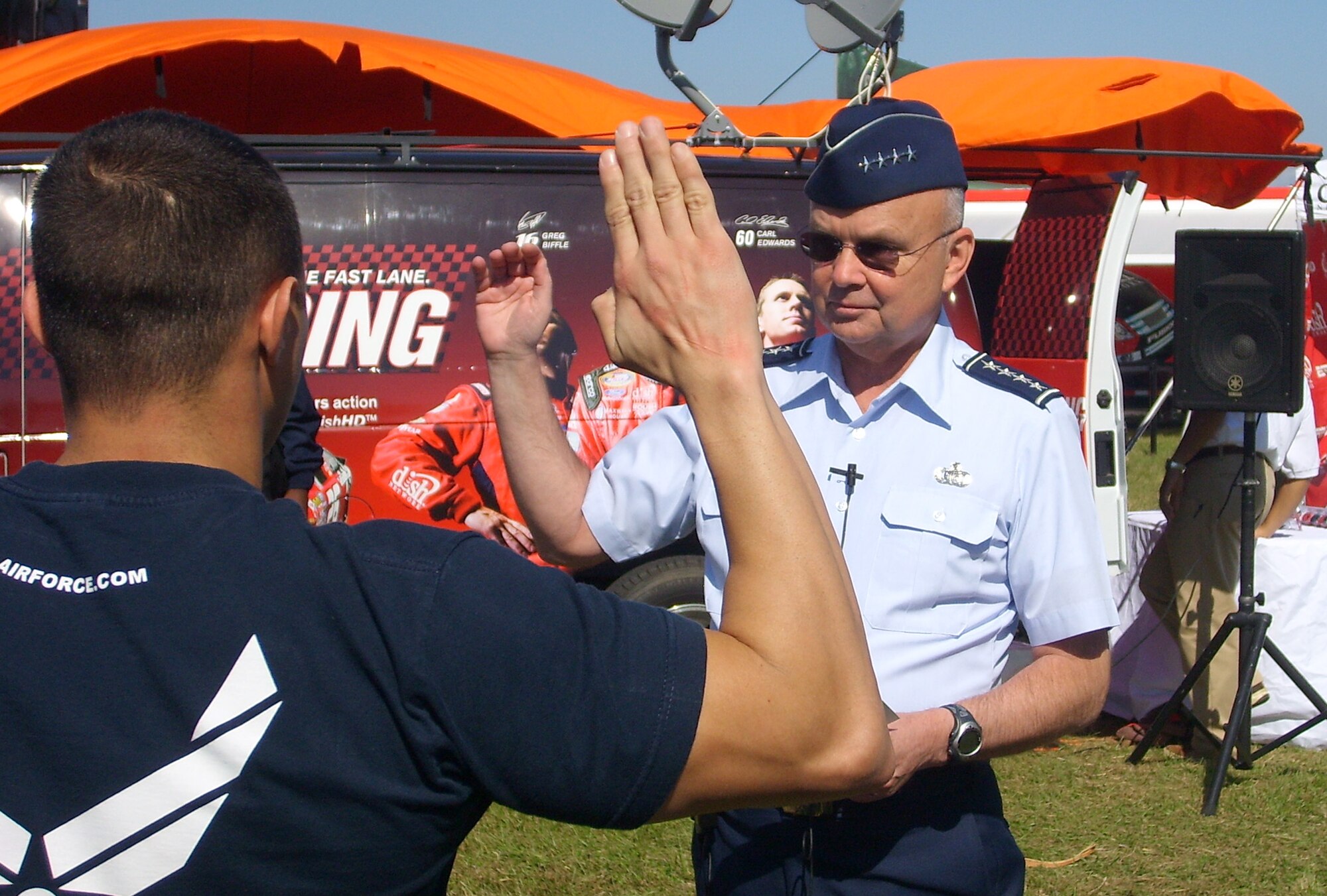 General Michael V. Hayden, director of the Central Intelligence Agency, conducts the oath of enlistment for several new members of the Delayed Enlistment Program during NASCAR's last event of the season held at Homestead-Miami Speedway, Nov. 18. (Air Force photo/Staff Sgt. Jeff Storman)