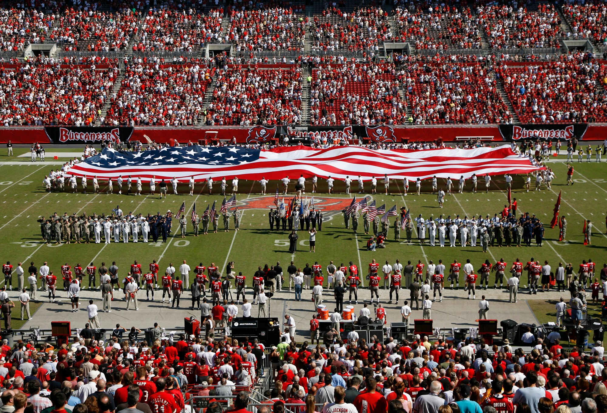 Delayed Enlistment Program members stretched a giant flag over the field during pre-game ceremonies at a Nov. 4 NFL game between the Tampa Bay Buccaneers and the Arizona Cardinals. (Air Force photo/Staff Sgt. Jeff Storman)
