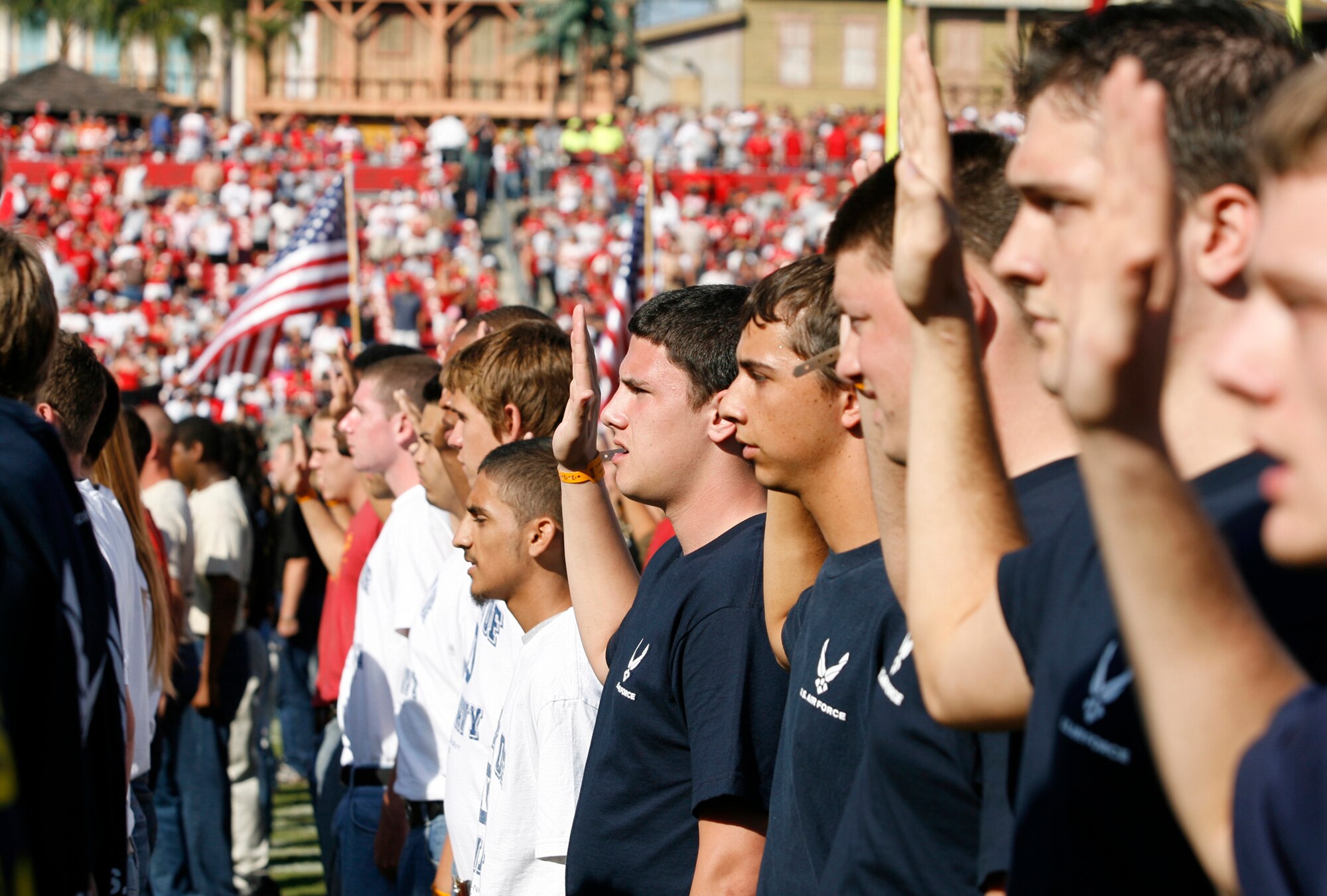 Thirty new airmen join the Air Force's Delayed Enlistment Program during a Military Appreciation Day swear-in ceremony at a Tampa Bay Buccaneers football game, Nov. 4.  The Air Force enlistees were among other new military members joining other Service branches. (Air Force photo/Staff Sgt. Jeff Storman)