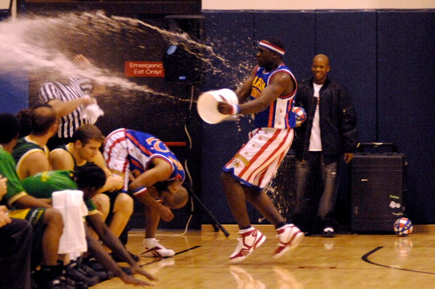 A member of the Harlem Globetrotters interacts with the audience by throwing water on them during a basketball game at the Dragon Fitness Center Dec.1 at Aviano Air Base, Italy. The Harlem Globetrotters are touring Army and Air Force installations throughout Europe as part of their "Magic As Ever" 2008 world tour. (U.S. Air Force photo/Airman 1st Class Ashley Wood) 
