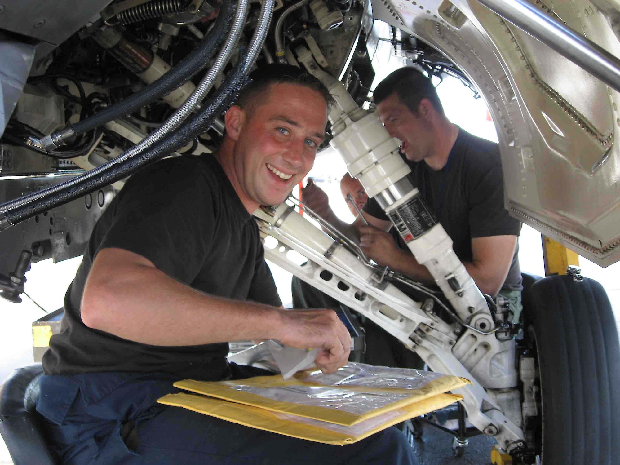 NELLIS AIR FORCE BASE, NEV. -- Staff Sgt. Brad Miner, 55th Aircraft Maintenance Unit dedicated crew chief, replaces all asociated hydraulic lines and tubing from the aircraft "B" system hydraulic pressure manifold Nov. 15. The F-16 was damaged by a fire caused by a hydraulic leak Nov. 14. The damaged aircraft was fixed, inspected and flew by Nov. 19. (U.S. Air Force photo/Chief Master Sgt. Michael Preston)
