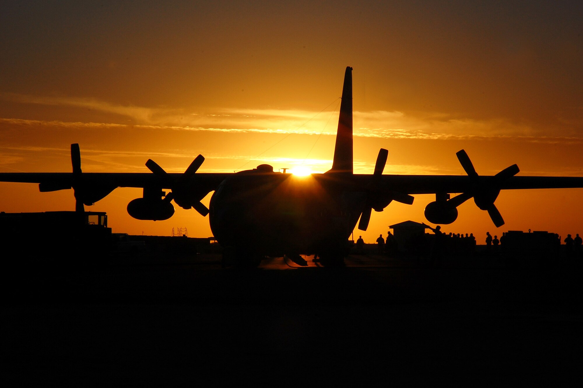 Servicemembers en route to Iraq prepare to board a C-130 Hercules Nov. 30 at an air base in Southwest Asia.  The C-130 is capable of operating from rough, dirt strips and is the prime transport for air dropping troops and equipment into hostile areas.  (U.S. Air Force photo/Staff Sgt. Tia Schroeder)