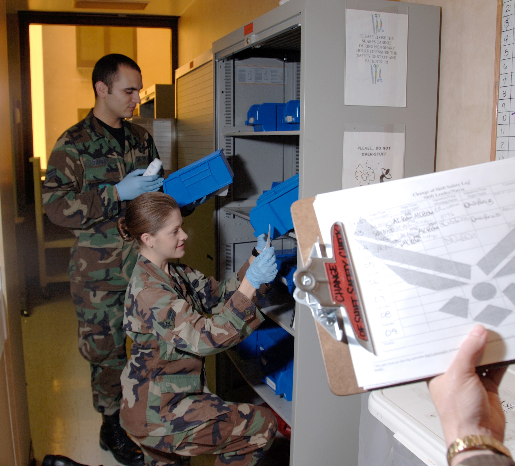 Airman First Class Leah Bolen (right) and Senior Airman Gustavo Pages (left) perform shift change safety checks on the mental health ward at Wilford Hall Medical Center Dec. 5.  Safety checks are done each day prior to shift change to ensure the well being of staff and patients. Airmen Bolen and Pages, are mental health technicians assigned the 59th Mental Health Squadron. (U.S. Air Force photo/Master Sgt. Kimberly A Yearyean-Siers)