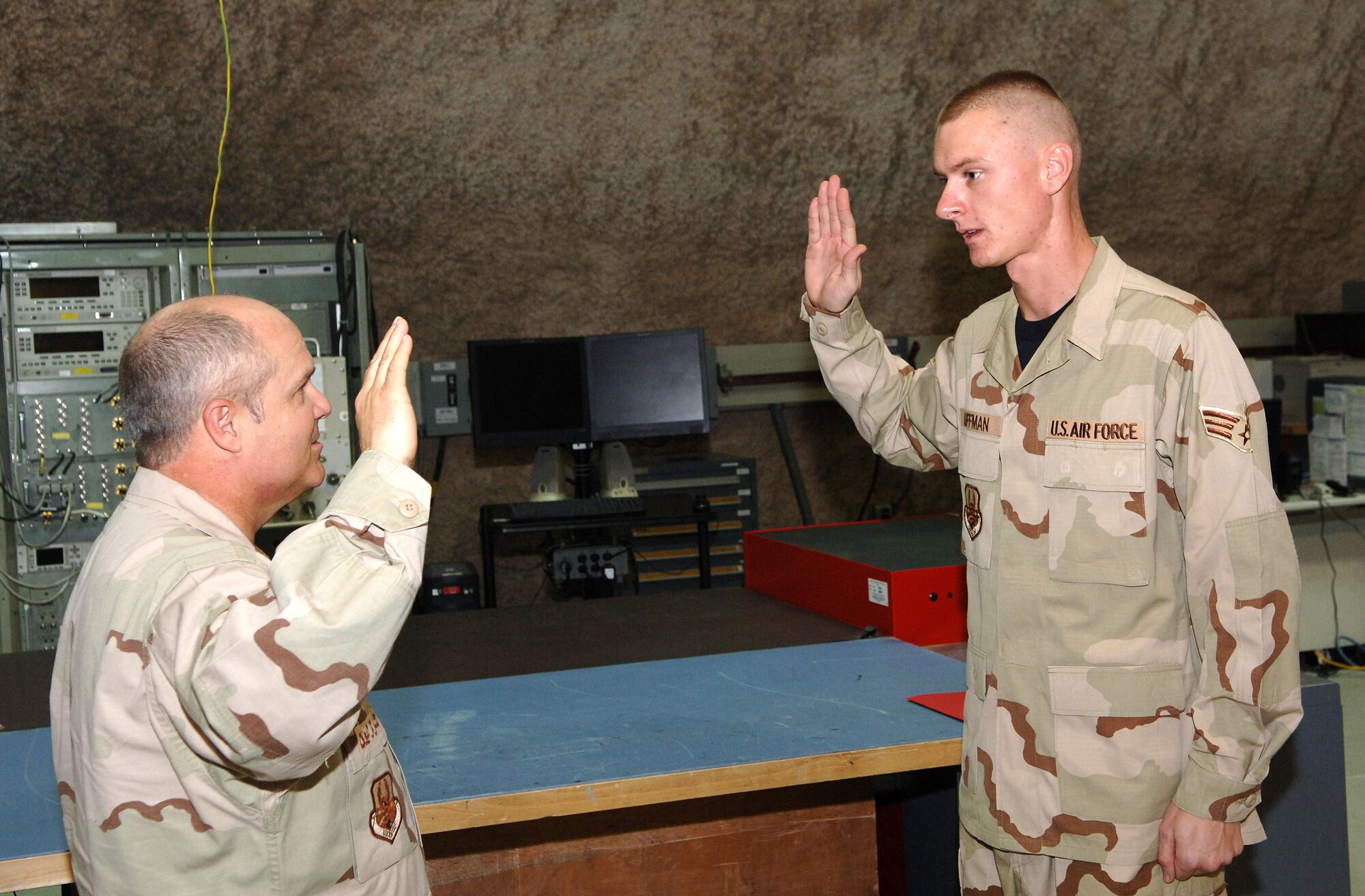 SOUTHWEST ASIA - Brig. Gen. Charlie Lyon, 379th Air Expeditionary Wing commander, administers the oath of enlistment to Senior Airman Gregory Huffman, 379th Expeditionary Maintenance Squadron F-15E avionics specialist, at a Southwest Asia air base. Airman Huffman is deployed from Seymour Johnson AFB, N.C. (U.S. Air Force photo/Master Sgt. Greg Kunkle)