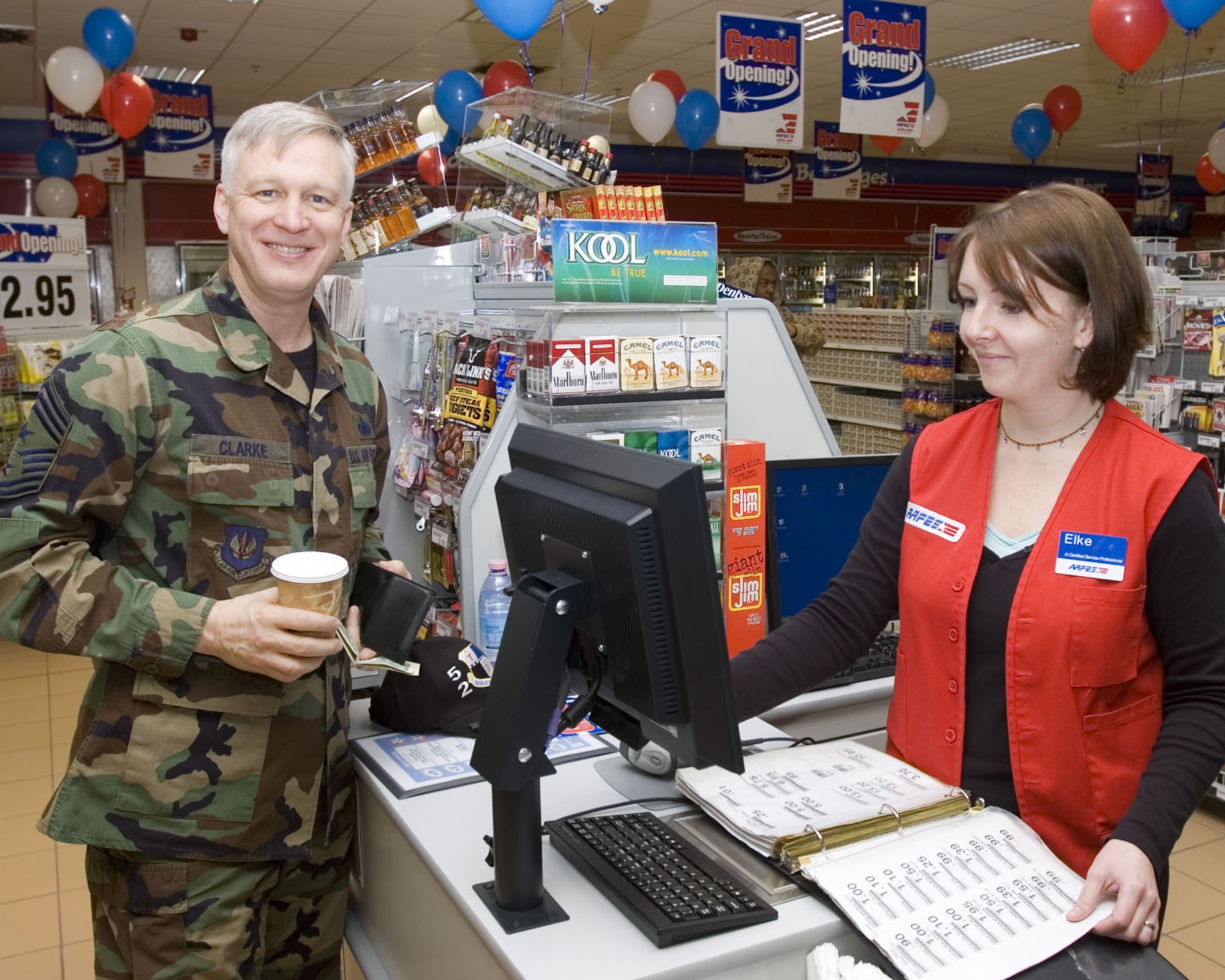 SPANGHDALEM AIR BASE, Germany – Chief Master Sgt. Vance Clarke, 52nd Fighter Wing command chief, waits as Elke Mansir, shoppette cashier, rings up his purchase. The new center which houses the base’s shoppette, car care center and gas station, opened Dec. 5, 2007. (U.S. Air Force photo/Staff Sgt. Chris Mills)