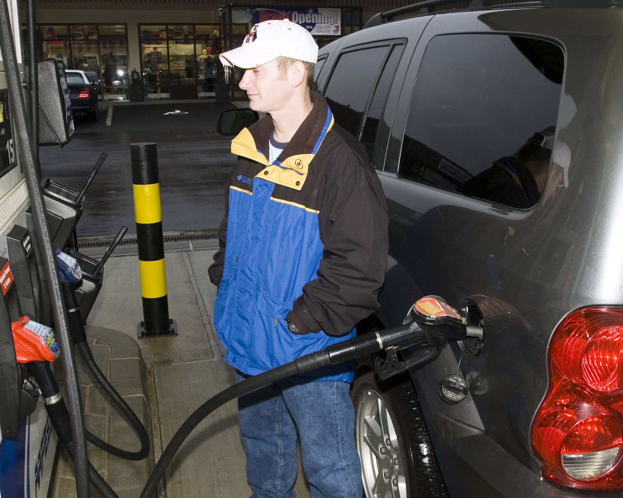 SPANGHDALEM AIR BASE, Germany – Airman 1st Class Matthew Angel, 52nd Logistics Readiness Squadron, is one of the first customers to refuel at the new consolidated shoppette at Spangdahlem Air Base. The new facility houses the base shoppette, gas station and car care center Dec. 5, 2007. (U.S. Air Force photo/Staff Sgt. Chris Mills)