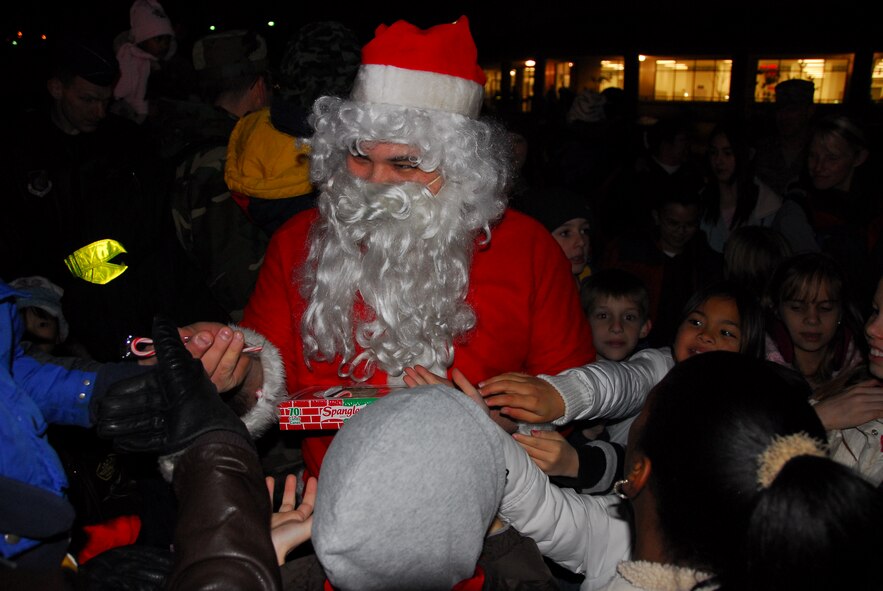 OSAN AIR BASE, Republic of Korea --  Santa Claus, escorted by 51st Security Forces Squadron, meets with children of all ages during the Christmas tree lighting celebration in front of the base theater Dec. 6. (U.S. Air Force photo by Staff Sgt. Ronnie Hill)