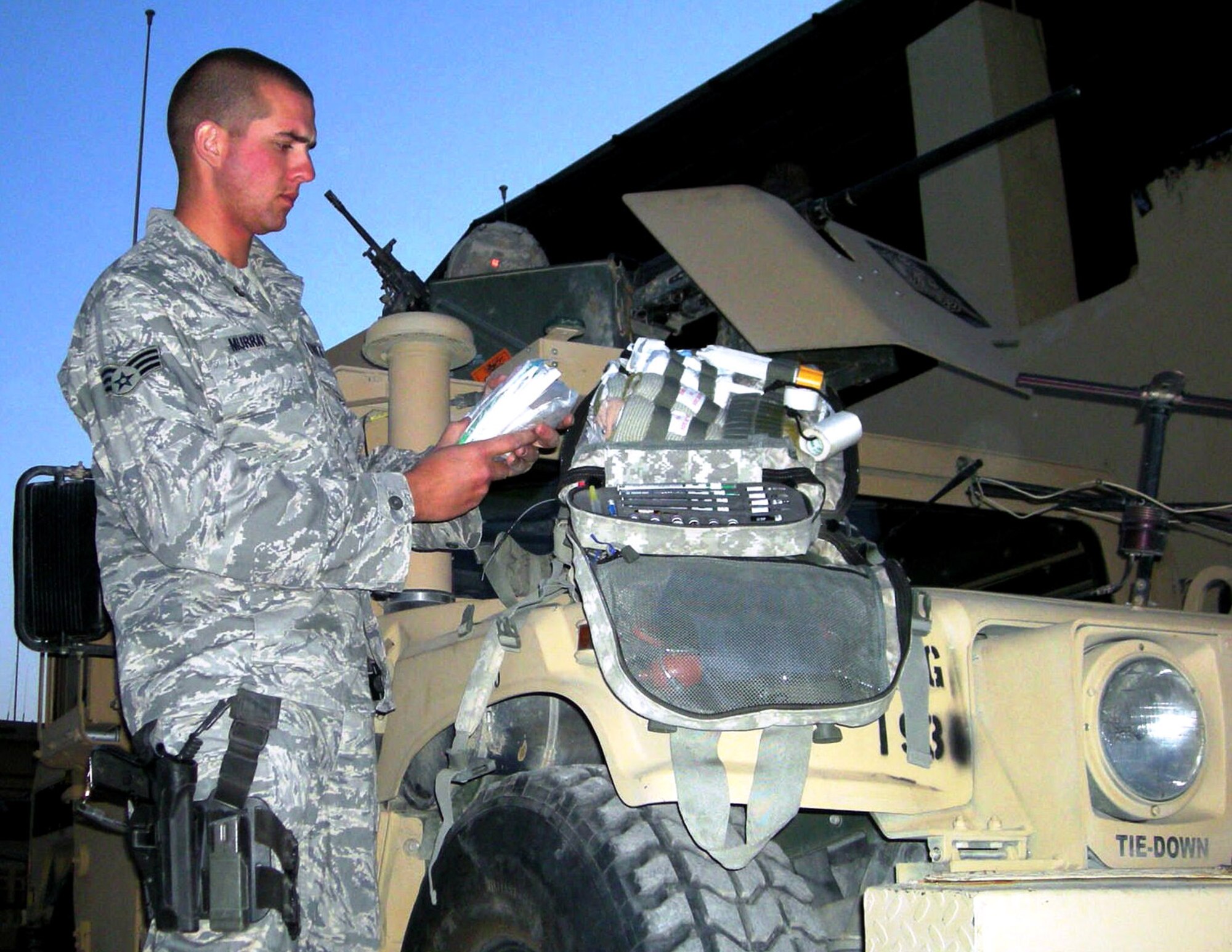 Senior Airman Neil Murray stocks his medical bag before heading out on a convoy Dec. 4 at Forward Operating Base Maholic, Afghanistan. Airman Murray is a combat medic here. Combat medics are usually the first to treat wounded servicemembers and stabilize them for transport to medical facilities. (U.S. Army photo/Spc. Daniel Richardson)