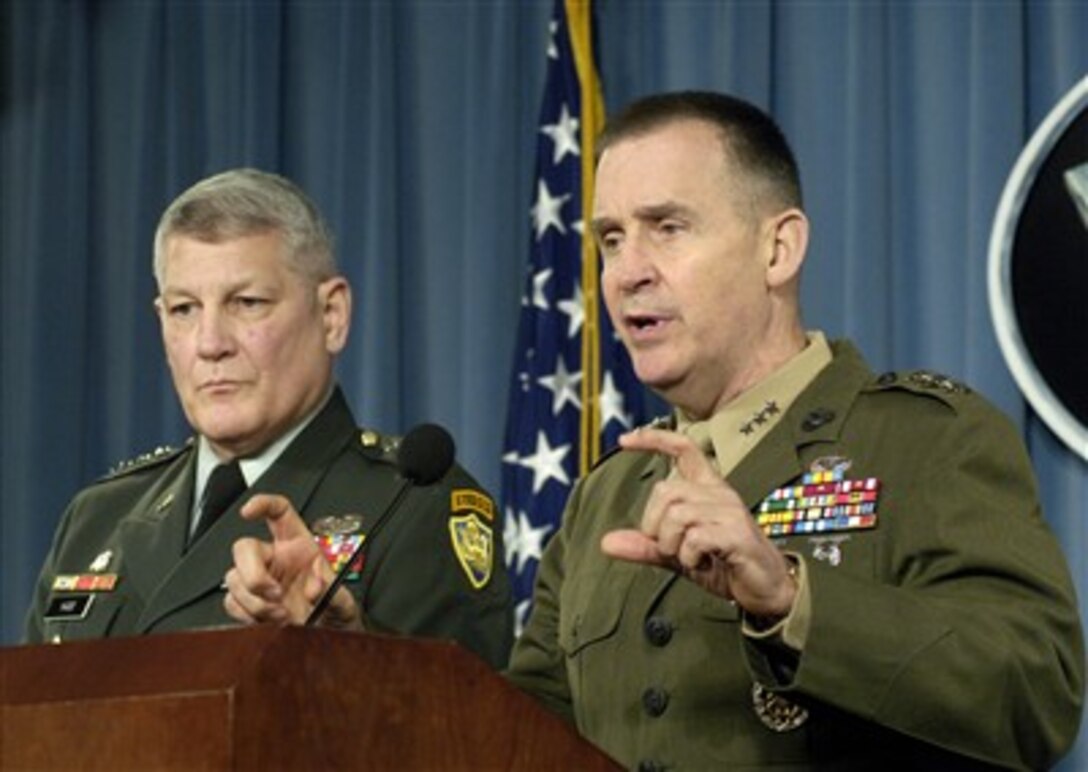 Director for Strategic Plans and Policy Lt. Gen. John Sattler (right), U.S. Marine Corps, responds to a reporter's question during a joint press briefing with Director for Operations Lt. Gen. Carter Ham (left), U.S. Army, in the Pentagon on Dec. 7, 2007.  