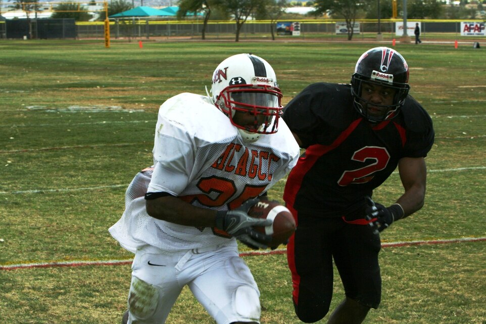 Ron Hampton, Headquarters Battalion running back, stretches the sideline and runs past Miramar?s defense to give his team the advantage at the Best of the West Football Championship at Felix Field Dec. 8.
