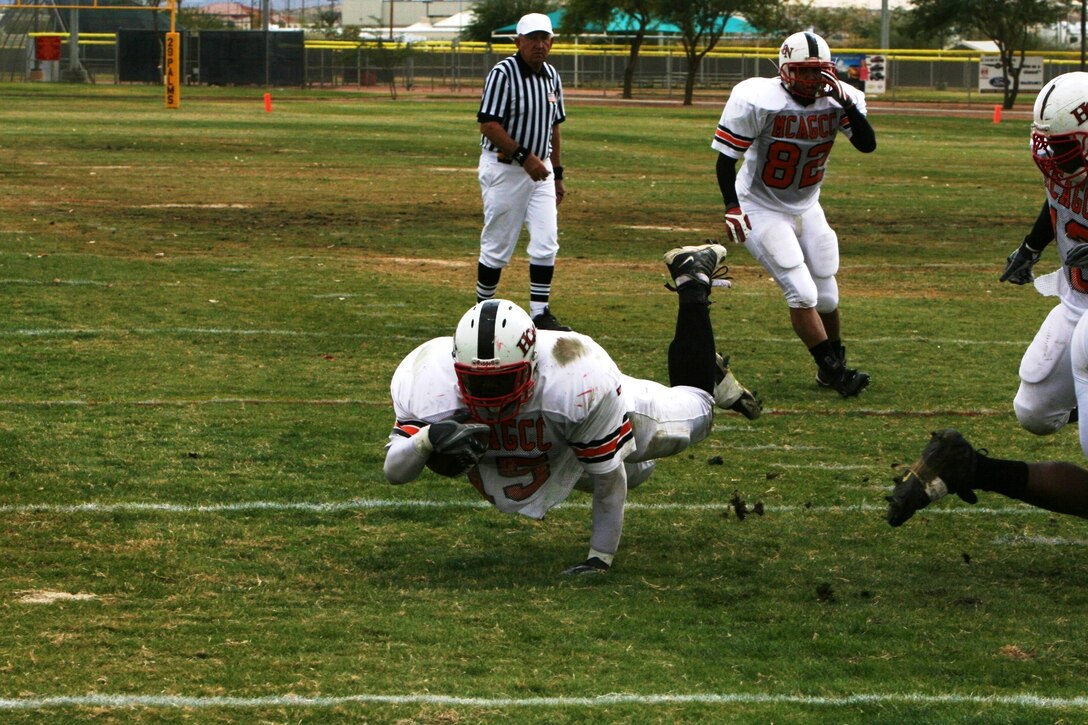 Jay Kwentua, Headquarters Battalion running back, dives for more yards at the Best of the West Football Championship at Felix Field Dec. 8.