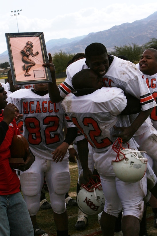 Charles Jefferson, Headquarters Battalion quarterback, celebrates after winning the game?s most valuable player award at the Best of the West Football Championship at Felix Field Dec. 8.