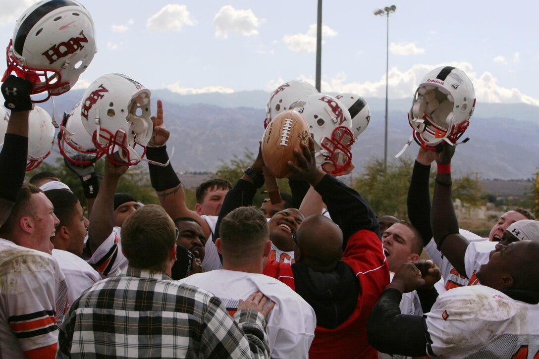 The Headquarters Battalion football team celebrates after a 28-26 victory over Miramar at the Best of the West Football Championship at Felix Field Dec. 8.