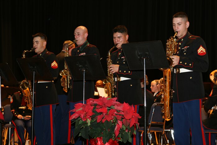 A Marine with Military Transition Team 1st Battalion, 3rd Brigade, 1st Iraqi Army Division hands out treats to young Iraqi children at a school near Abu Hazim on Dec 8. MTT 1-3-1 is currently deployed within Iraq?s Al Anbar Province to help develop Iraqi Security Forces, facilitate the development of official rule of law through democratic government reforms and continue the development of a market based economy centered on Iraqi reconstruction.