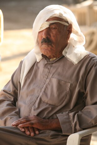 An elderly Iraqi man sits outside a school near Abu Hazim where Marines and sailors of Military Transition Team 1st Battalion, 3rd Brigade, 1st Iraqi Army Division and Iraqi soldiers with 1st Battalion, 3rd Brigade, 1st Iraqi Army Division were passing out school supplies. MTT 1-3-1 is currently deployed within Iraq?s Al Anbar Province to help develop Iraqi Security Forces, facilitate the development of official rule of law through democratic government reforms and continue the development of a market based economy centered on Iraqi reconstruction.