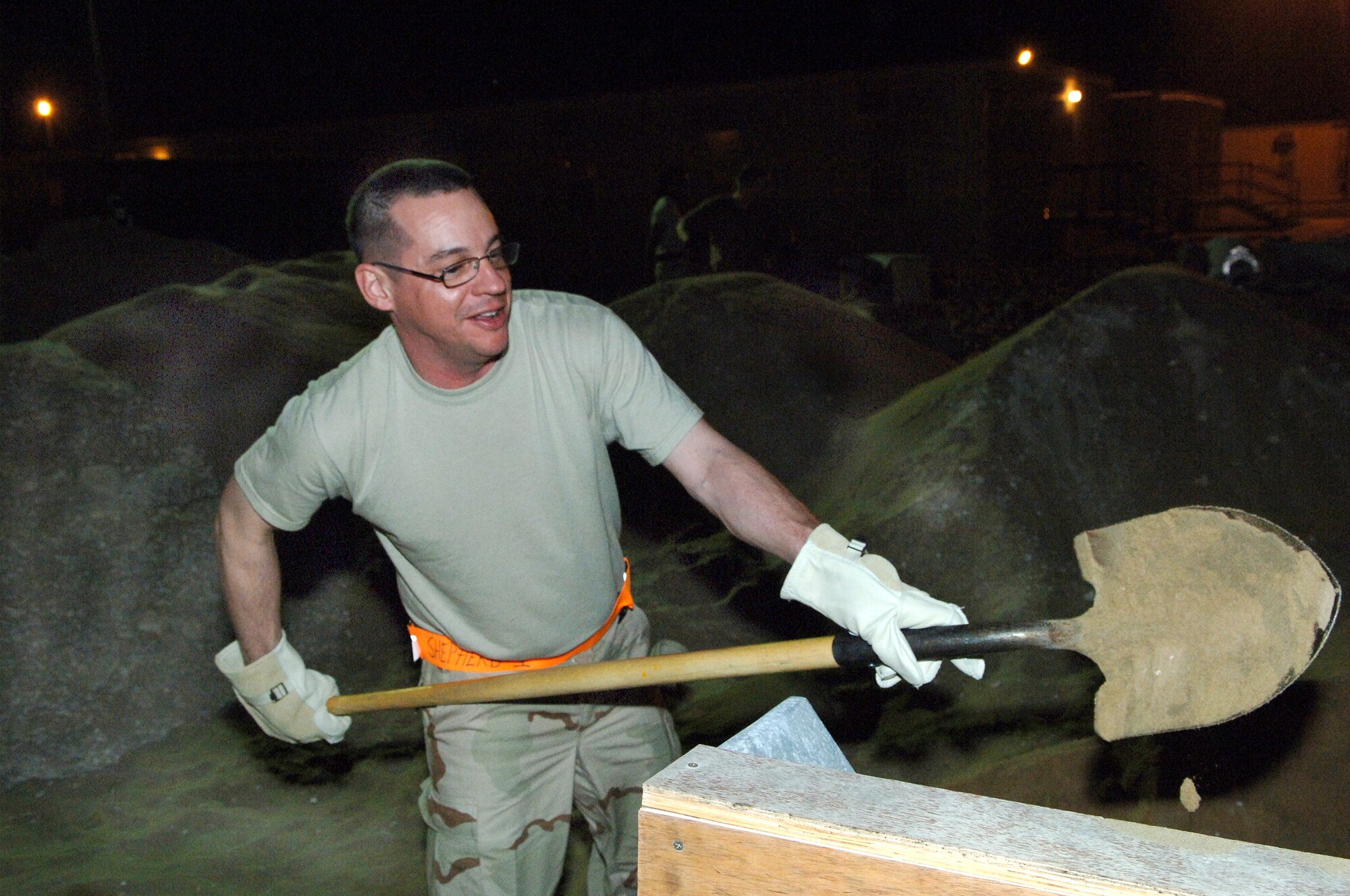 SOUTHWEST ASIA - Chaplain (Capt.) Jason English assists other 379th Air Expeditionary Wing personnel by shoveling sand to help fill sandbags during a detail at a Southwest Asia air base. Captain English is deployed from Aviano AB, Italy. (U.S. Air Force photo/Master Sgt. Greg Kunkle)