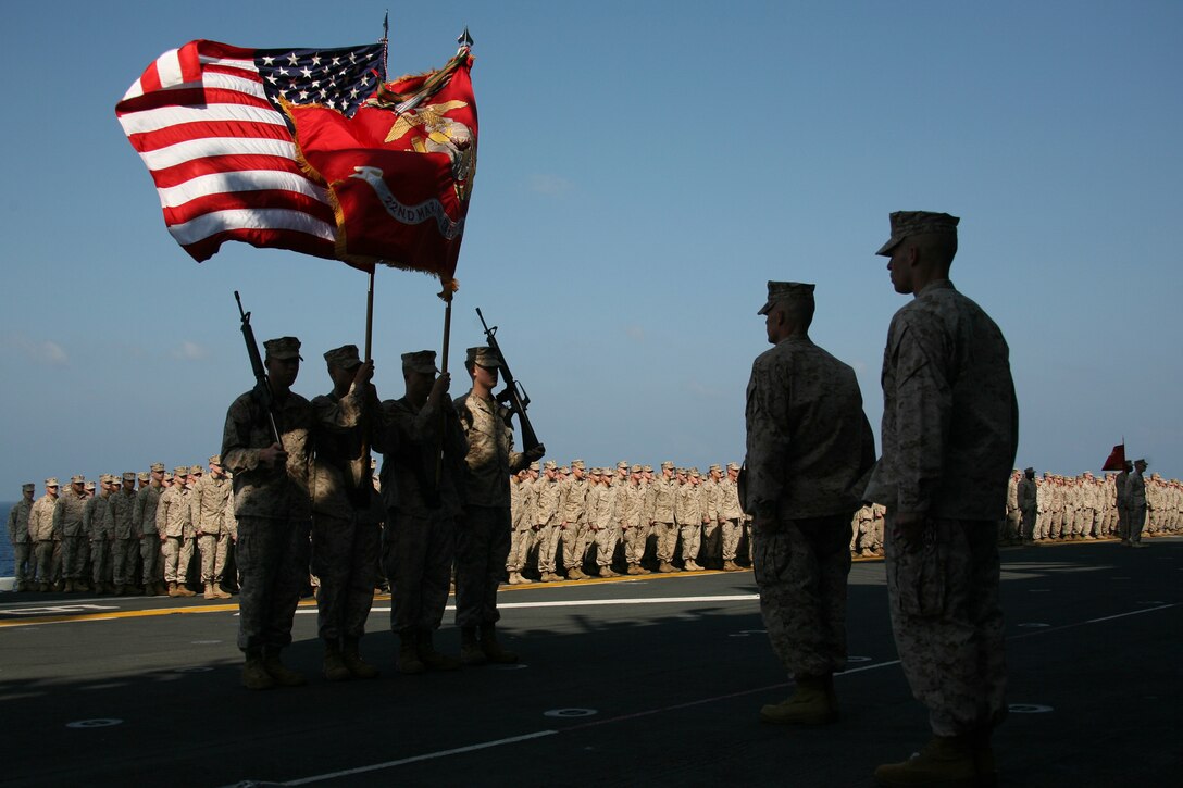 The 22nd Marine Expeditionary Unit (Special Operations Capable) color guard marches in the colors as the unit celebrated its 25th anniversary aboard USS Kearsarge Dec. 8, 2007. Three streamers representing the Afghanistan Campaign Medal, the Global War on Terrorism Service Medal and the Iraq Campaign Medal were added to the unit colors. (Official Marine Corps Photo by Cpl. Peter R. Miller)